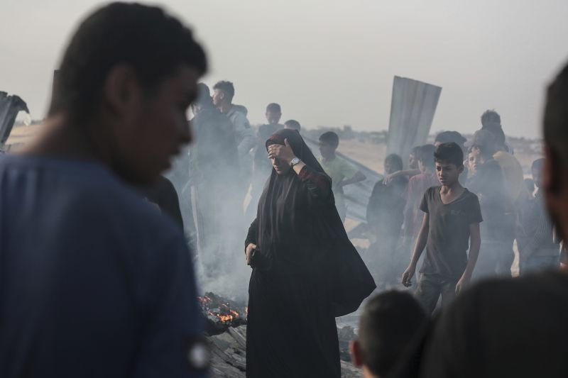 Palestinians look at the destruction after an Israeli strike where displaced people were staying in Rafah, Gaza Strip, Monday.