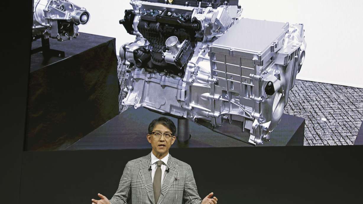 Koji Sato, chief executive of Toyota, speaks in Tokyo, Tuesday. Toyota introduced plans for a new lean compact motor that will cast a futuristic spin on the traditional internal combustion engine.