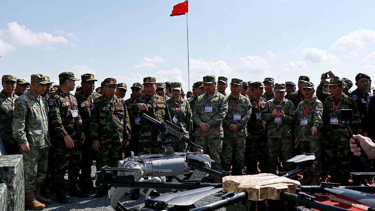 Cambodian and Chinese military leaders attend a demonstration of a machine gun-equipped robot battle "dog" in the Kampong Chhnang province of Cambodia on May 16.