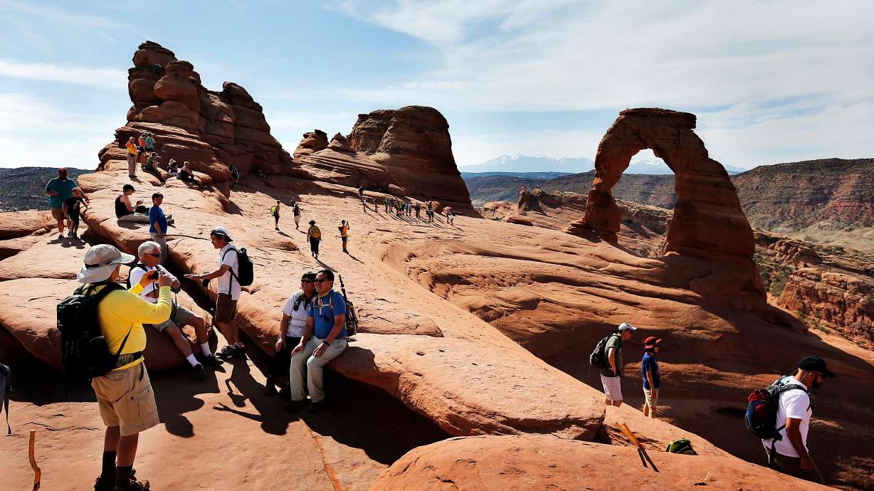 Tourists gather at Delicate Arch in Arches National Park, June 3, 2016. From feeding wild animals to perilous selfies, tourists risk their lives and the preservation of America’s national parks for fleeting social media fame.