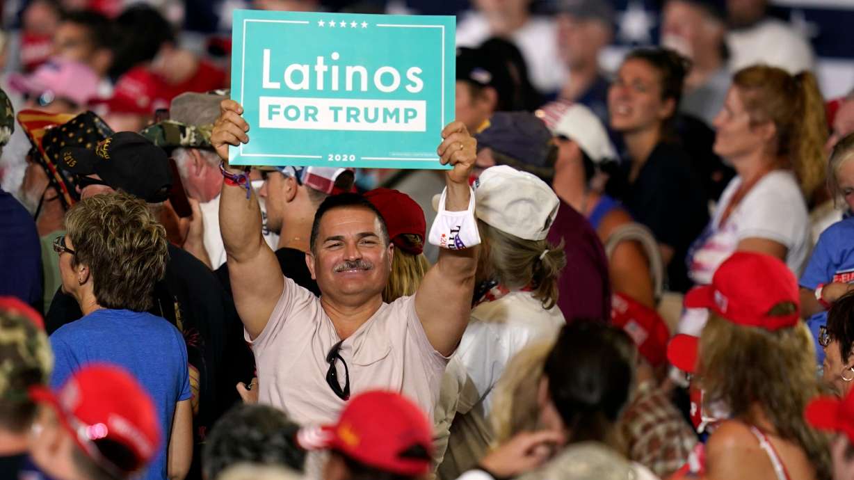 A supporter holds a sign as President Donald Trump speaks Aug. 28, 2020, in Londonderry, N.H. Poll after poll shows Trump has been gaining ground among Hispanics.