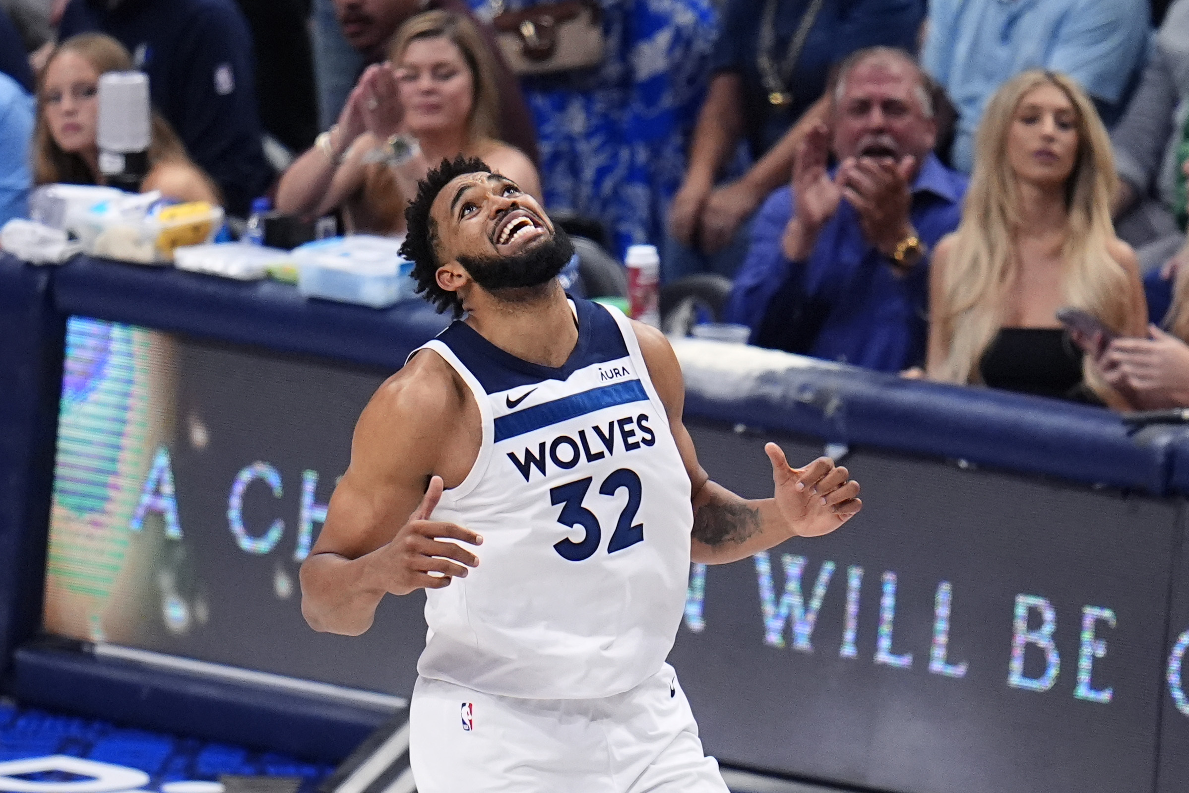 Minnesota Timberwolves center Karl-Anthony Towns (32) reacts to a play during the second half in Game 4 of the NBA basketball Western Conference finals against the Dallas Mavericks, Tuesday, May 28, 2024, in Dallas. 
