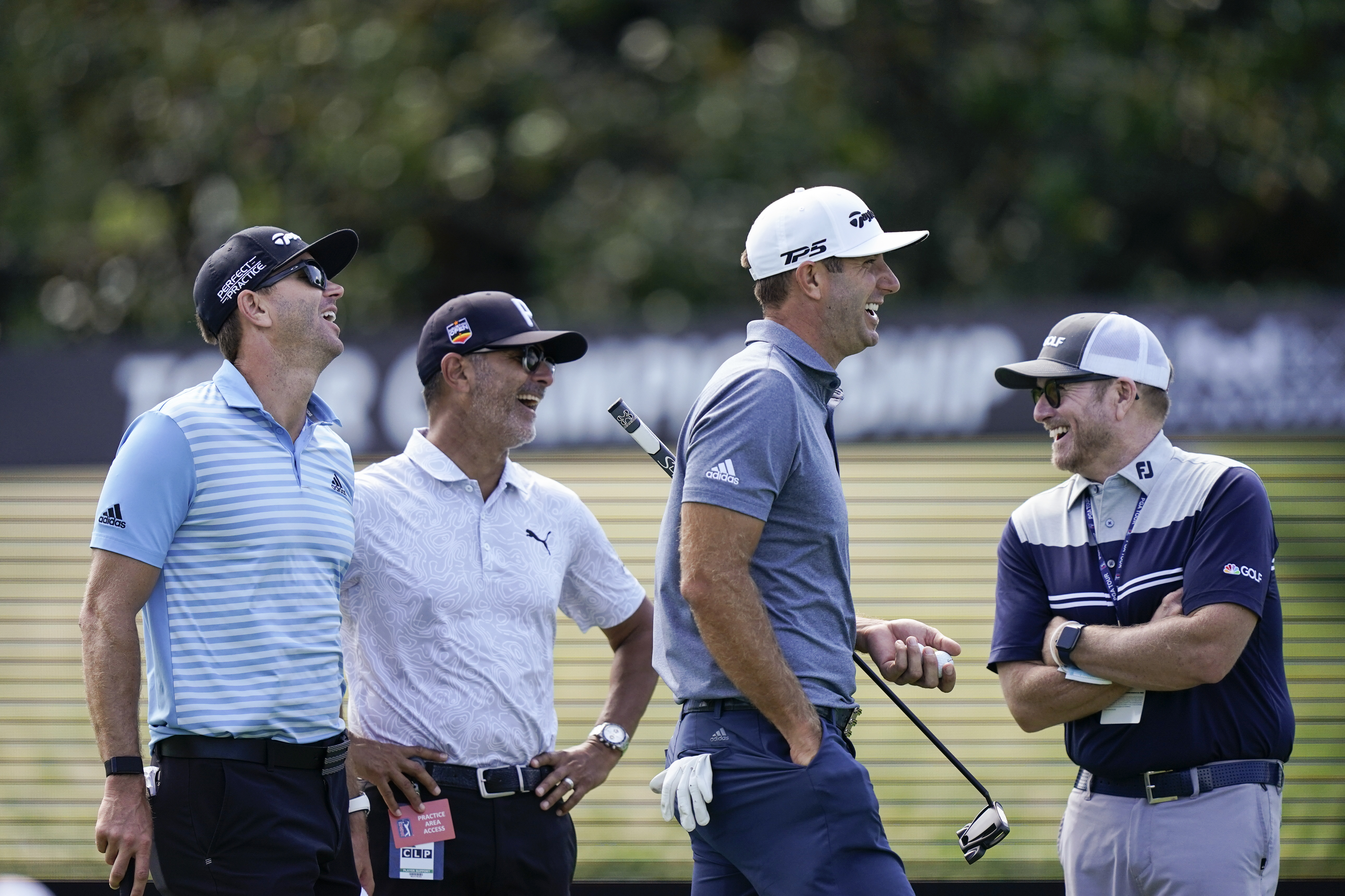 FILE - NBC on-course reporter John Wood, right, Dustin Johnson, second from right, Claude Harman, second from left and caddie Austin Johnson share a laugh during practice for the Tour Championship on Sept. 1, 2021, at East Lake Golf Club in Atlanta. Wood, a former caddie, has been appointed Ryder Cup team manager for the Americans.