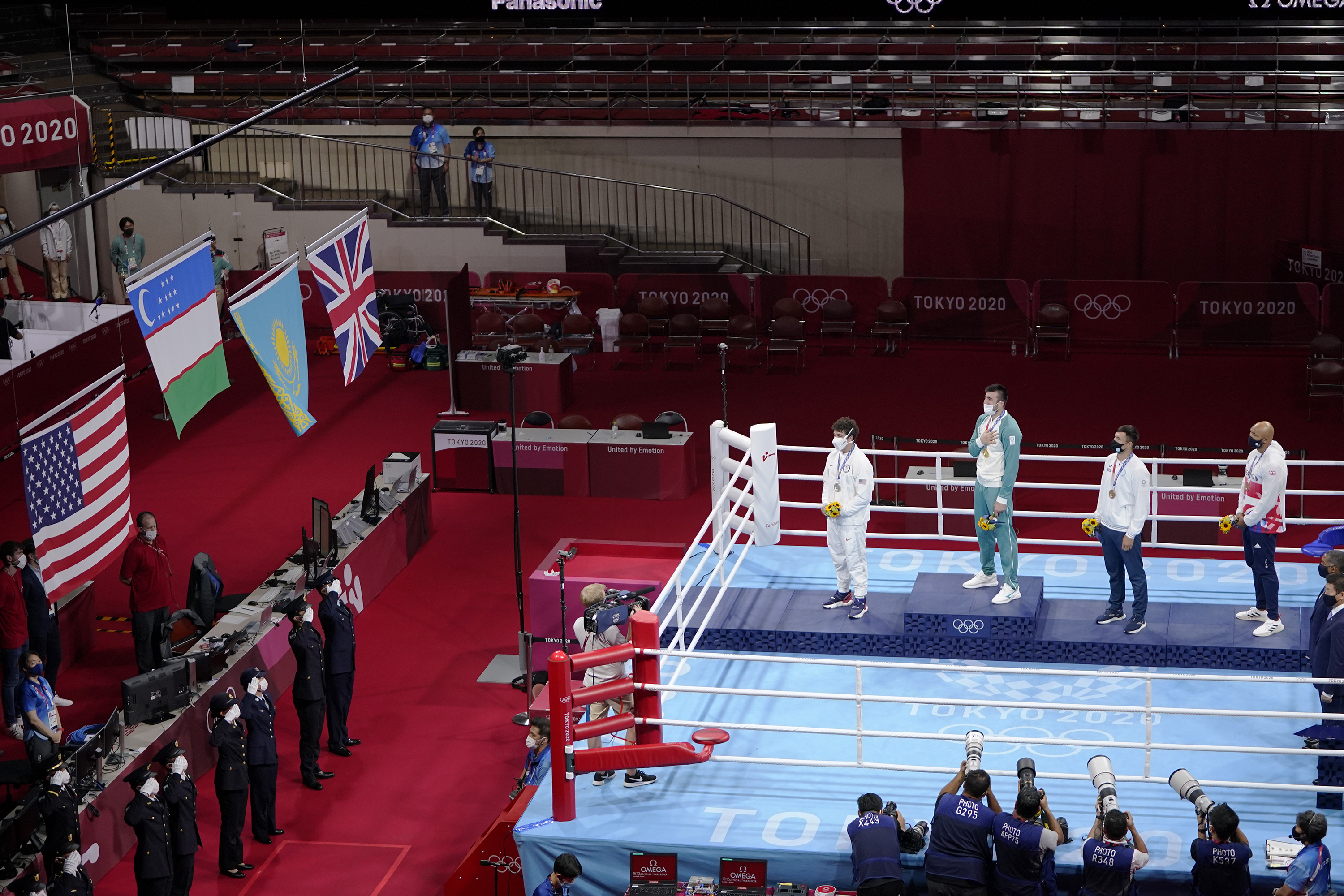 FILE - Silver medal winner Richard Torrez Jr., from the United States, left, Gold medal winner Uzbekistan's Bakhodir Jalalov, second from left, bronze medalists Kazakhstan's Kamshybek Kunkabayev, third from left, and Britain's Frazer Clarke, right, watch the flags of their respective nations being raised during the men's super heavyweight over 91-kg boxing medal ceremony at the 2020 Summer Olympics, Sunday, Aug. 8, 2021, in Tokyo, Japan. The boxing governing body declared rogue by the International Olympic Committee said Wednesday, May 29, 2024, it will pay $50,000 in prize money to each gold medalist at the Paris Games. 