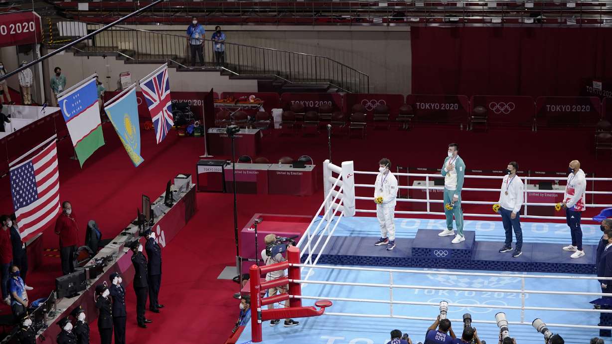 FILE - Silver medal winner Richard Torrez Jr., from the United States, left, Gold medal winner Uzbekistan's Bakhodir Jalalov, second from left, bronze medalists Kazakhstan's Kamshybek Kunkabayev, third from left, and Britain's Frazer Clarke, right, watch the flags of their respective nations being raised during the men's super heavyweight over 91-kg boxing medal ceremony at the 2020 Summer Olympics, Sunday, Aug. 8, 2021, in Tokyo, Japan. The boxing governing body declared rogue by the International Olympic Committee said Wednesday, May 29, 2024, it will pay $50,000 in prize money to each gold medalist at the Paris Games.