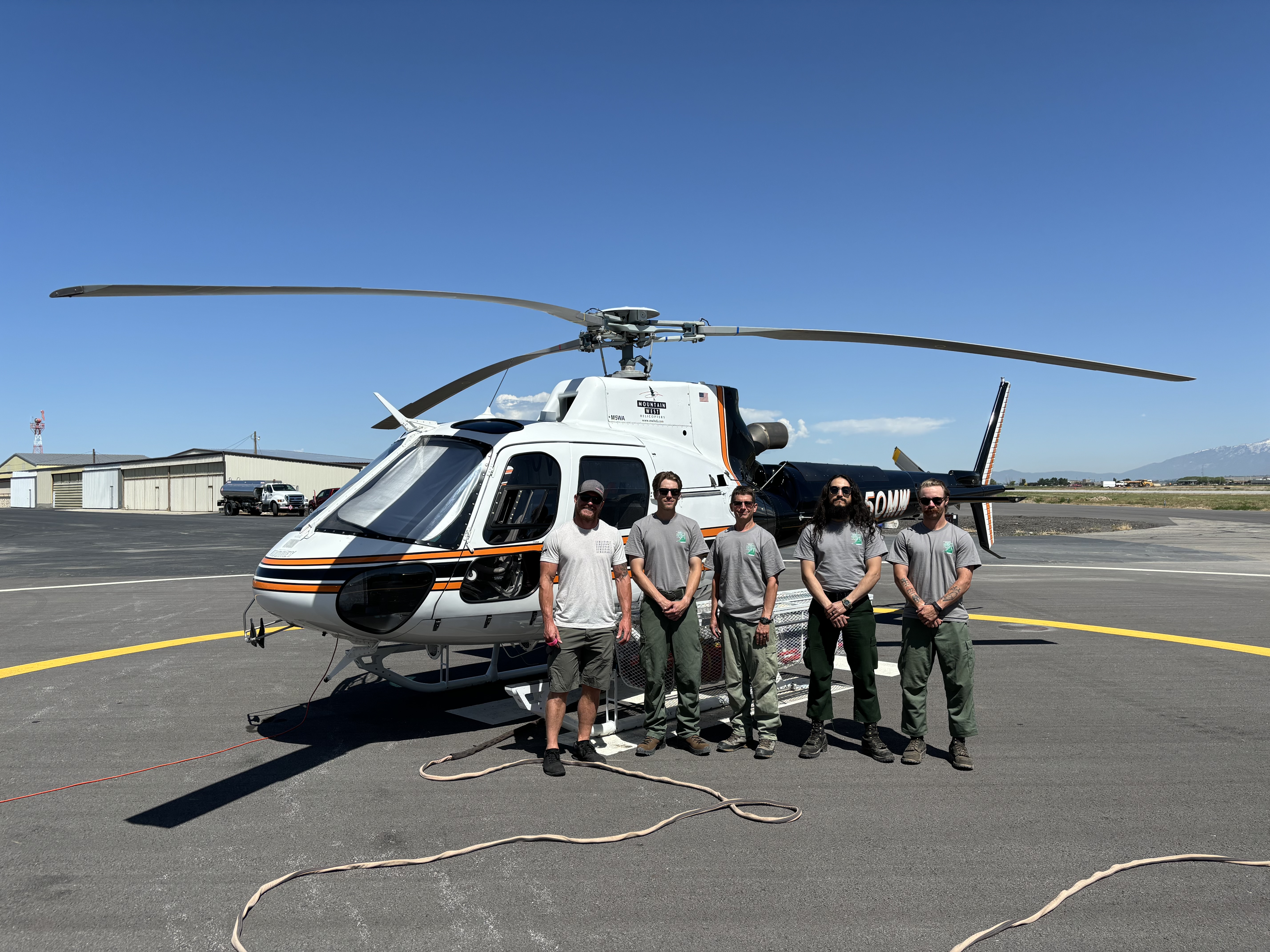 Members of the Diamond Fork Helitack crew pose in front of a new helicopter the state is contracting. The team will help with  first response when a new wildland fire begins.