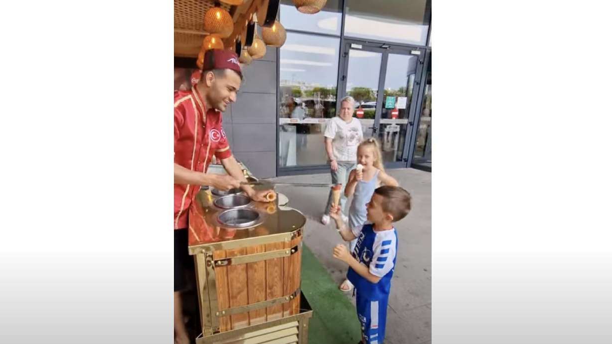 An ice cream vendor in Turkey plays a silly prank on a young customer. Every time the little boy thinks he's secured his ice cream, it gets taken straight out of his hands.
