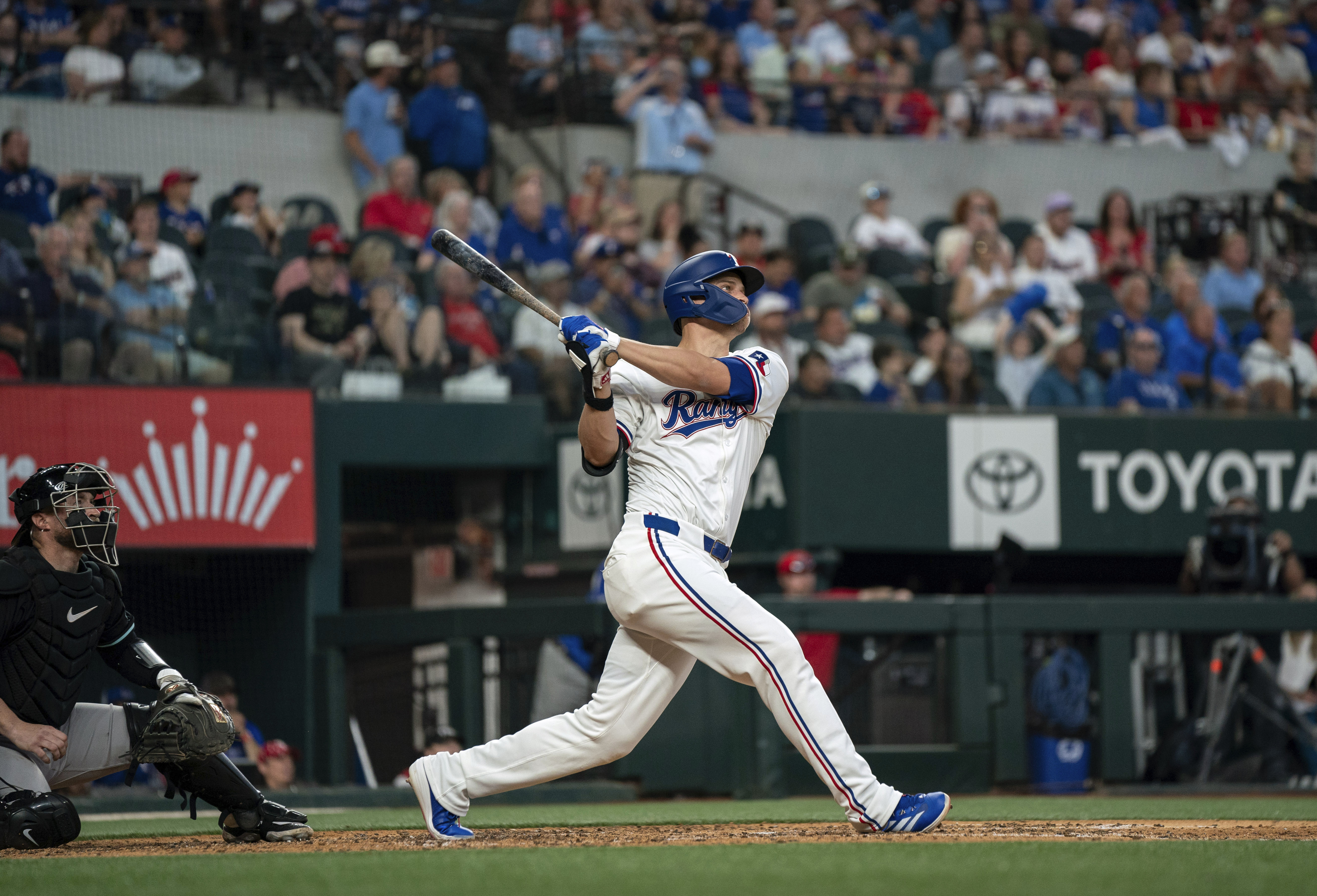 Texas Rangers' Corey Seager hits a two run home run off of Arizona Diamondbacks starting pitcher Ryne Nelson as Arizona Diamondbacks catcher Tucker Barnhart looks on during the fifth inning of a baseball game Wednesday, May 29, 2024, in Arlington, Texas. Ezequiel Duran scored on the play.