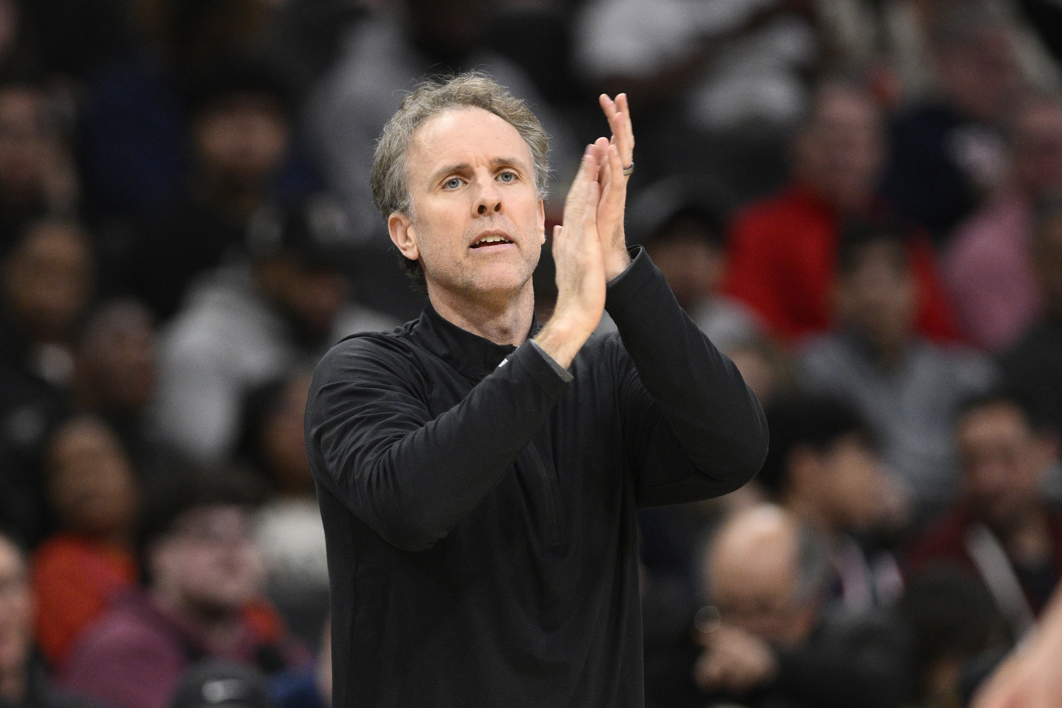 FILE - Washington Wizards interim head coach Brian Keefe applauds his players during the first half of an NBA basketball game against the Miami Heat, Sunday, March 31, 2024, in Washington. The Wizards hired Keefe as their coach on Wednesday, May 29, 2024, sticking with the man who led the team on an interim basis from late January until the end of the season.