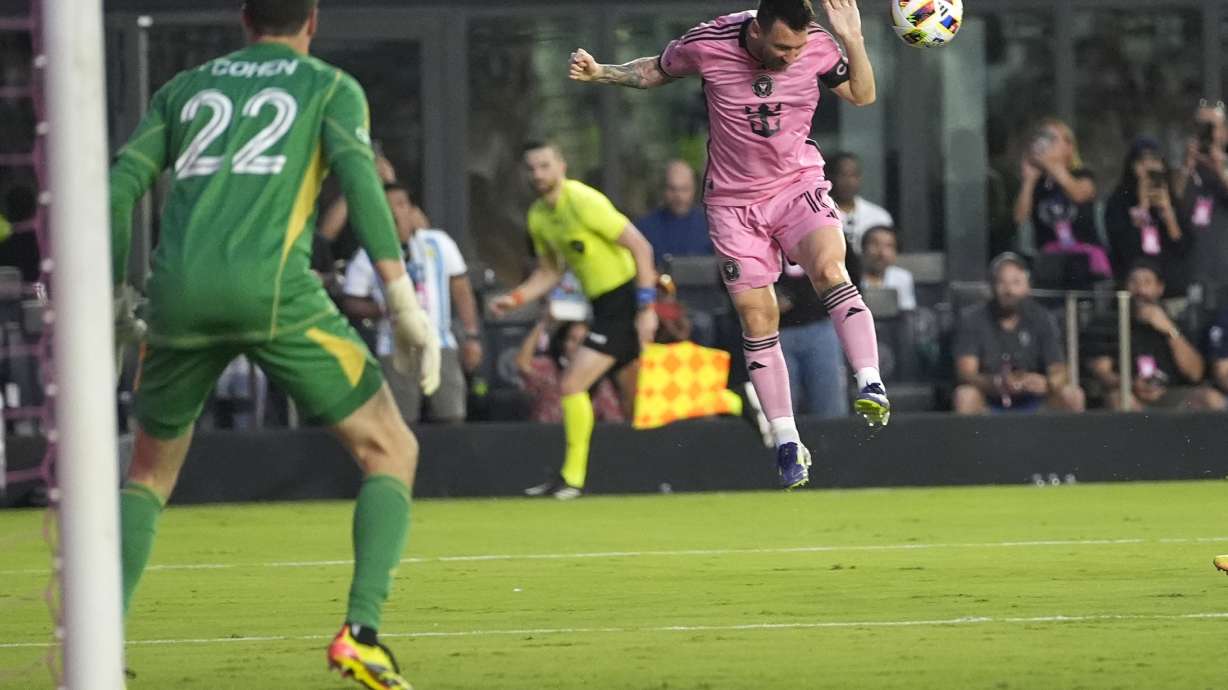 Inter Miami forward Lionel Messi, right, heads the ball as Atlanta United goalkeeper Josh Cohen (22) watches during the first half of an MLS soccer match Wednesday, May 29, 2024, in Fort Lauderdale, Fla.