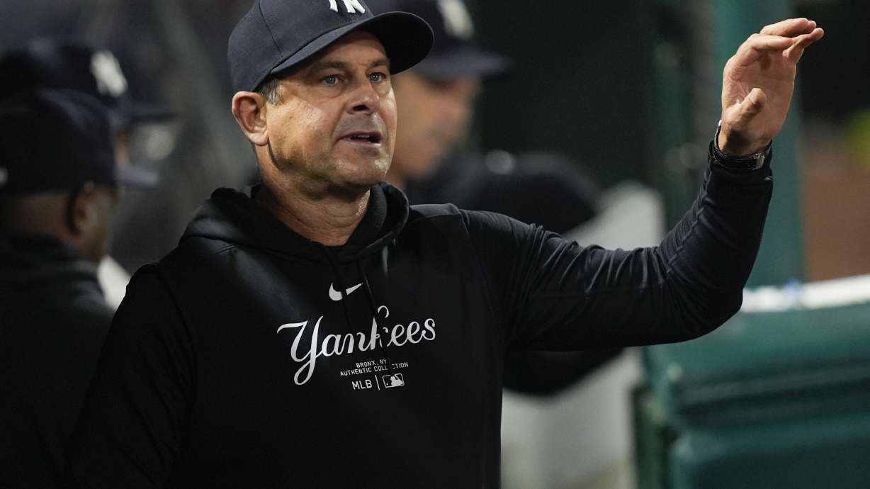 New York Yankees manager Aaron Boone walks in the dugout during the eighth inning of the team's baseball game against the Los Angeles Angels, Tuesday, May 28, 2024, in Anaheim, Calif.