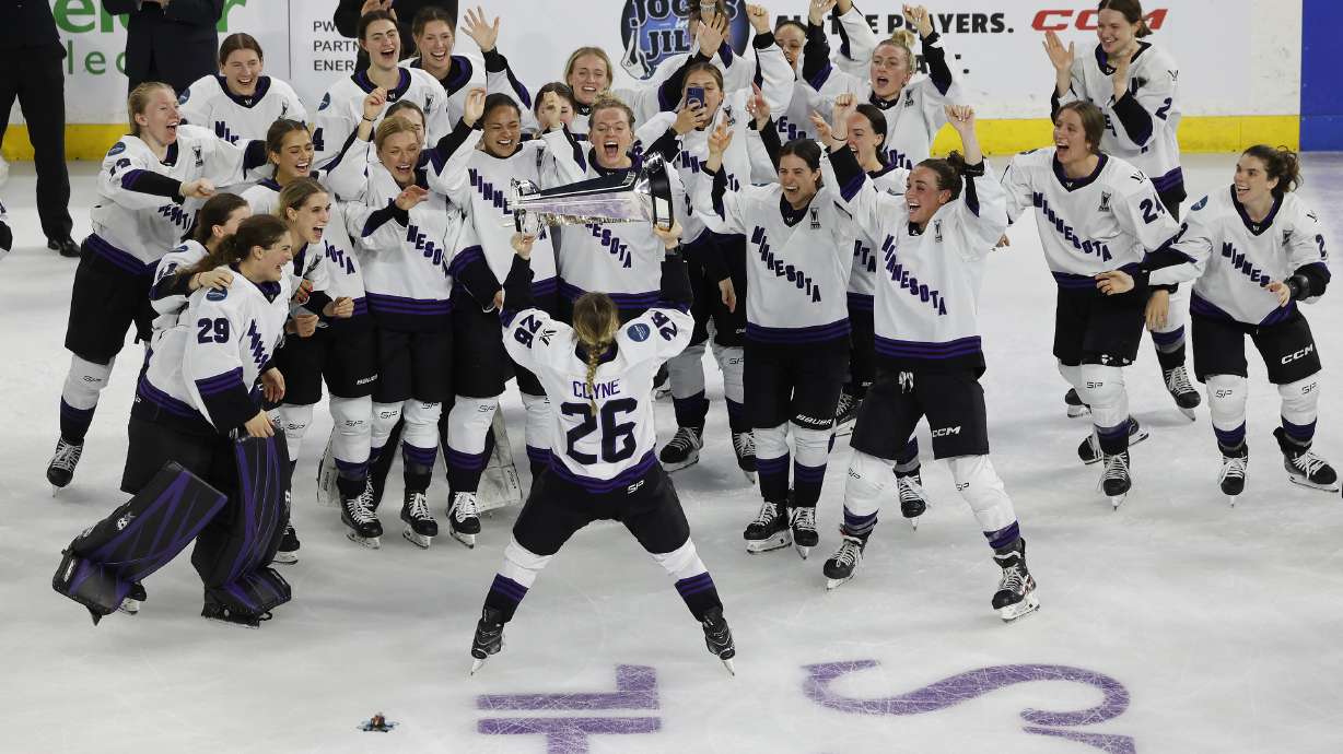 Minnesota captain Kendall Coyne Schofield (26) takes the trophy to her team after defeating Boston to win the PWHL Walter Cup, Wednesday May 29, 2024, in Lowell, Mass.