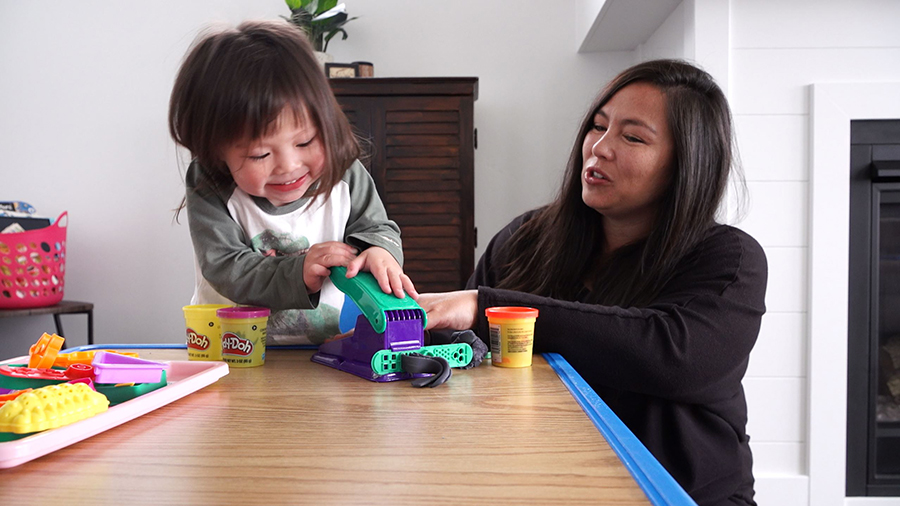 Sylvia Lam plays with her child.