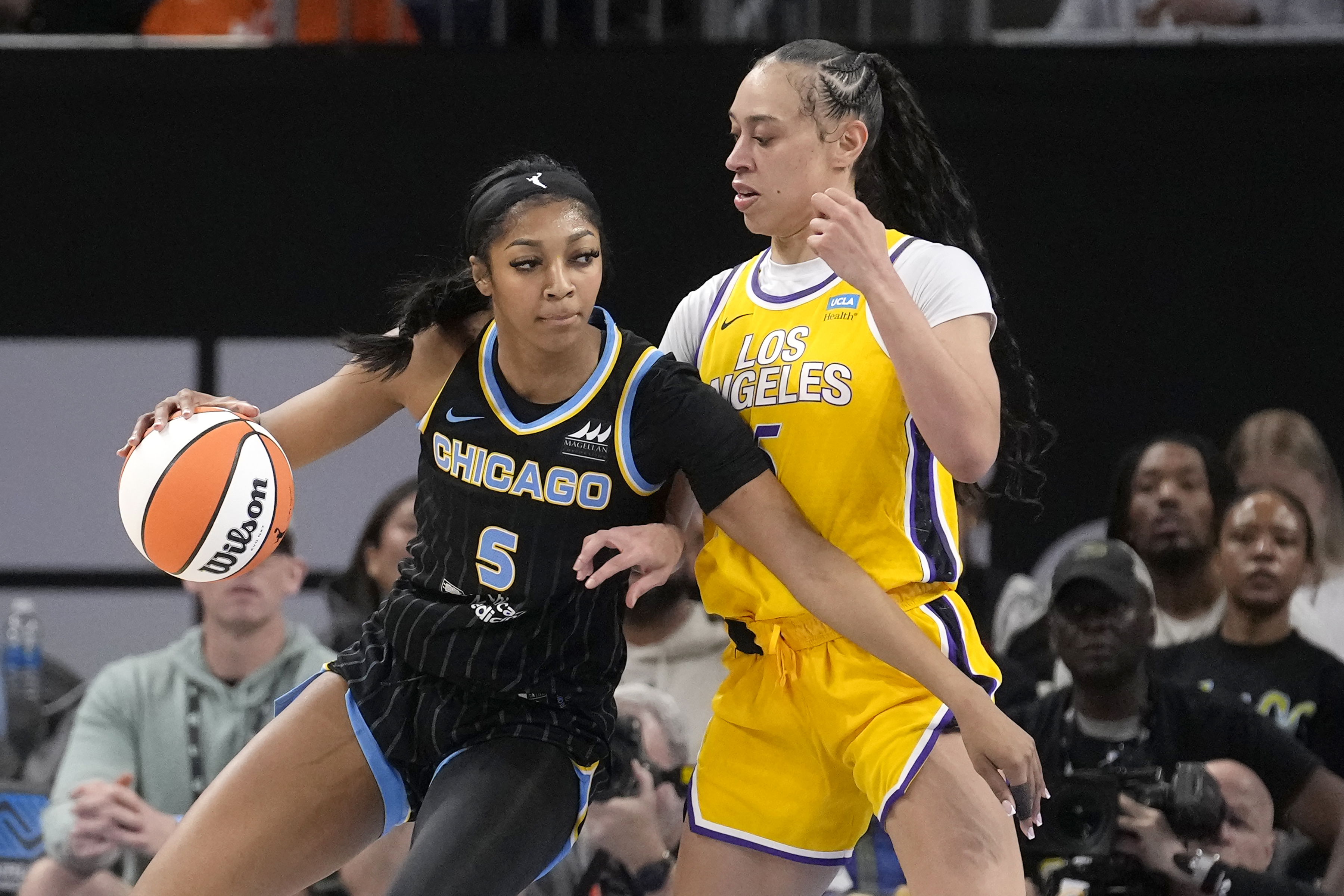 Chicago Sky's Angel Reese (5) drives to the basket as Los Angeles Sparks' Dearica Hamby defends during the first half of a WNBA basketball game Thursday, May 30, 2024, in Chicago. 