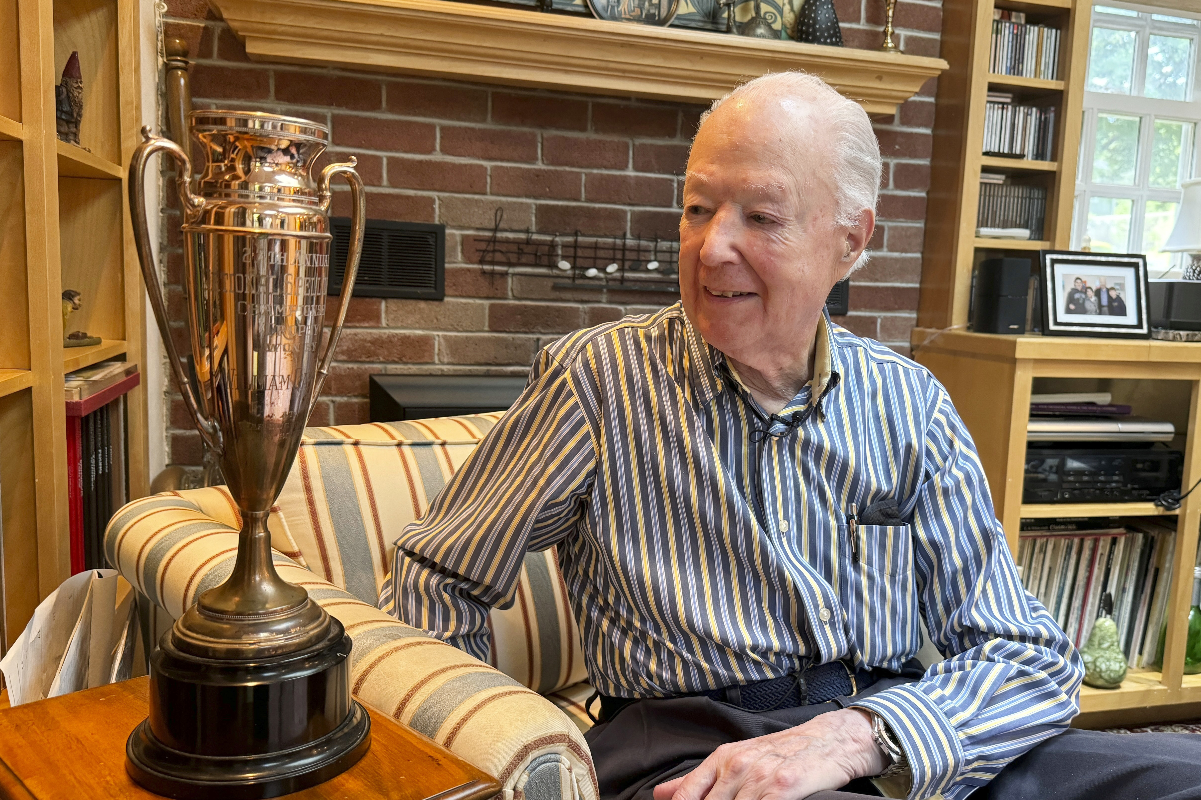William Cashore, 84, the 1954 Scripps National Spelling Bee championship trophy, is seen on Wednesday in Greenwich, R.I. 
