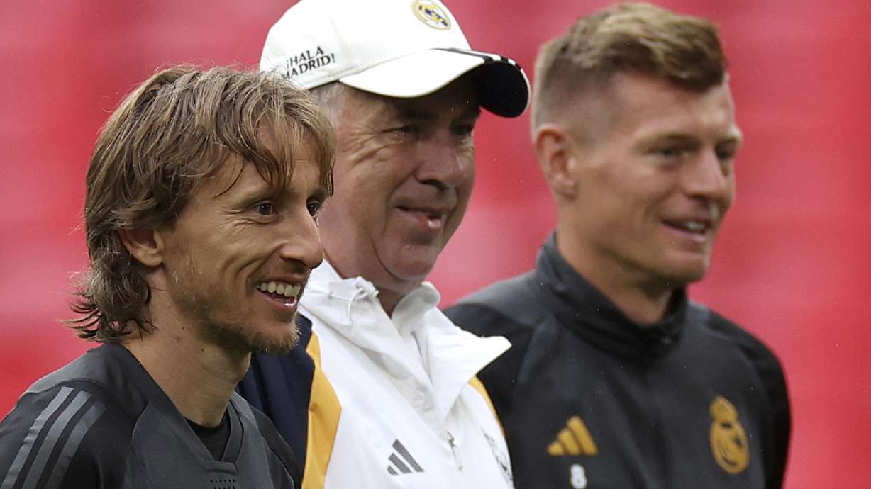 Real Madrid's Luka Modric, from left, Real Madrid's head coach Carlo Ancelotti and Real Madrid's Toni Kroos stand together during a training session ahead of the Champions League final soccer match between Borussia Dortmund and Real Madrid at Wembley Stadium in London, Friday, May 31, 2024.