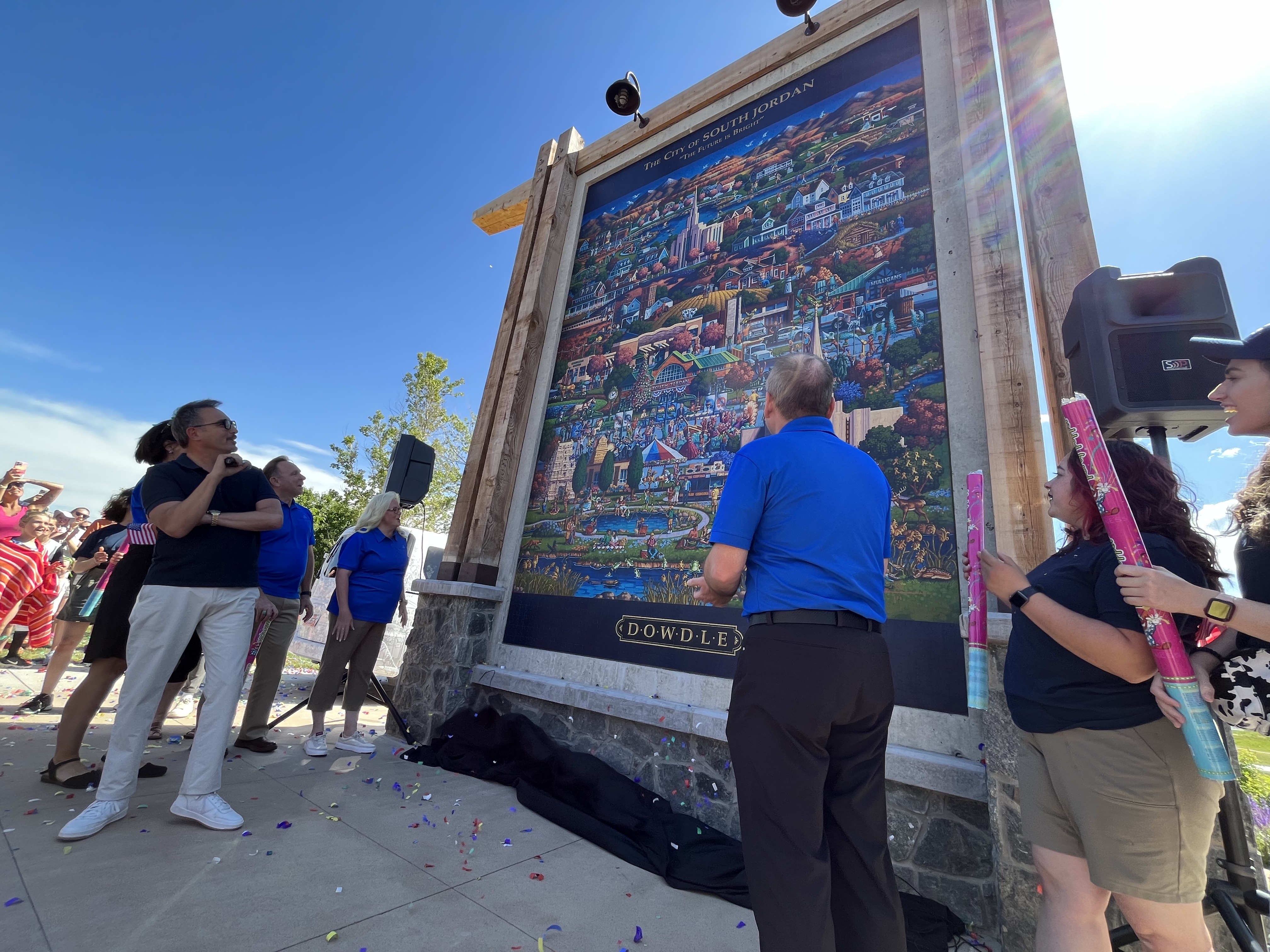 Folk artist and puzzlemaker Eric Dowdle unveils his new puzzle mural at Heritage Park in South Jordan.