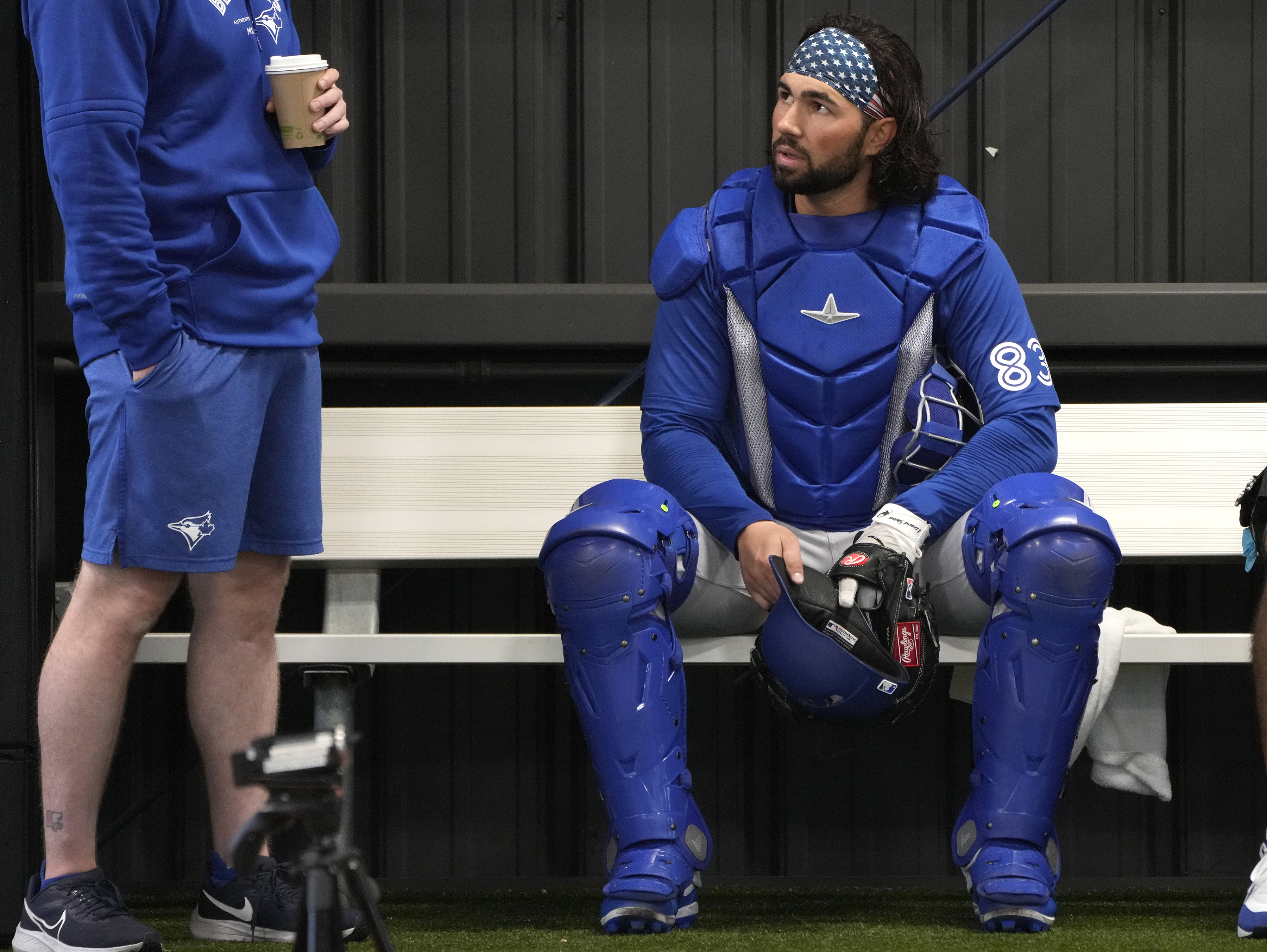FILE - Toronto Blue Jays catcher Payton Henry, right, sits in the bullpen during a baseball spring training workout Feb. 18, 2024, in Dunedin, Fla. Current Buffalo Bisons catcher Henry was hospitalized Friday, May 31, 2024, after he was struck by a batter's backswing and carted off the field on a stretcher. 