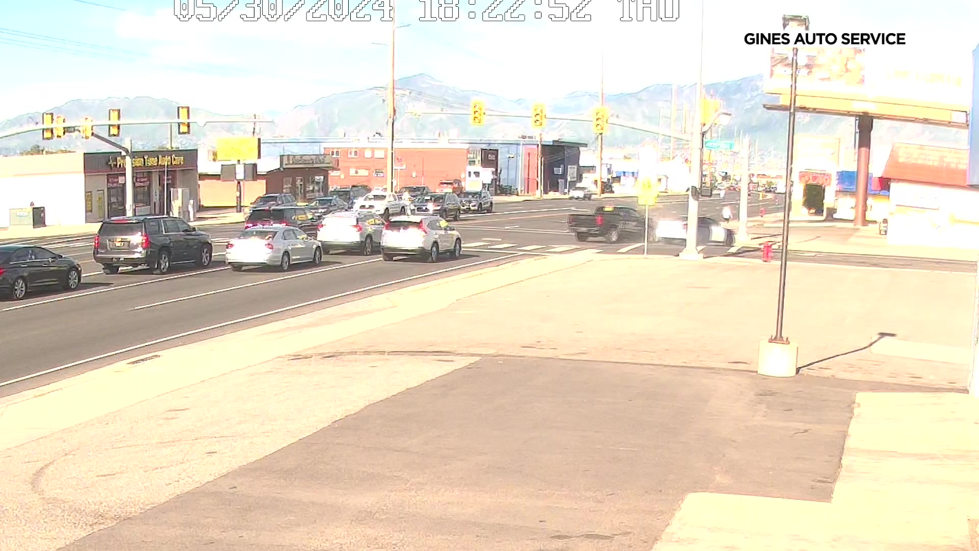 Surveillance video captures an alleged hit-and-run crash as a white car sped through a red light in Kearns Thursday.