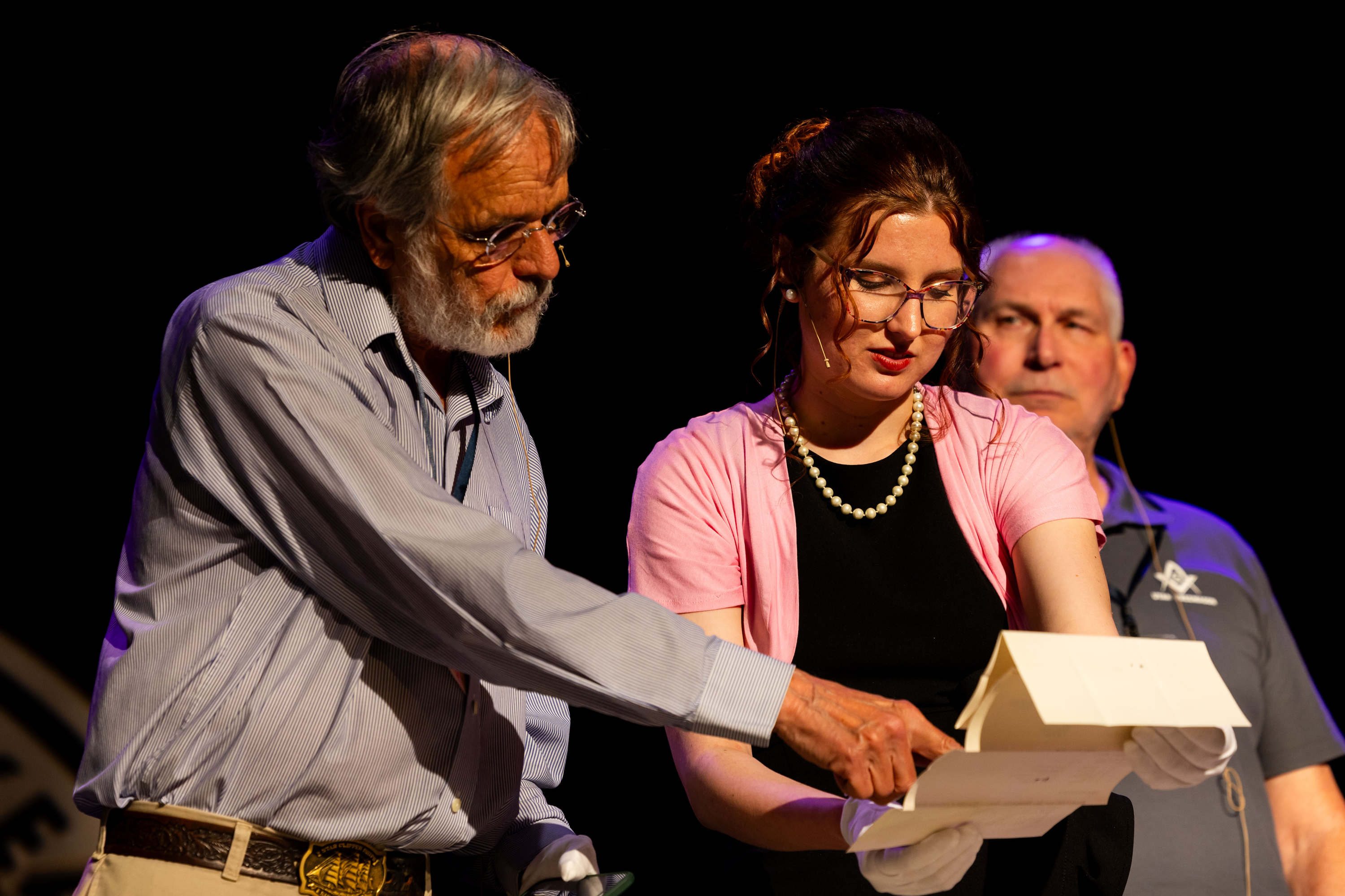 Charlie Trentelman, a local historian, and Hope Eggett, museum curator at Union Station, look at an artifact pulled out of a time capsule at a reveal ceremony at Union Station in Ogden on Friday. The time capsule was placed 100 years ago, on May 31, 1924, during the building of the station.