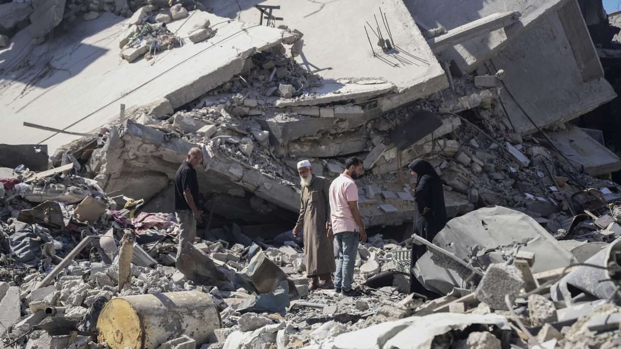 Palestinians sift through the rubble of their home in the wake of an Israeli air and ground offensive in Jebaliya, northern Gaza Strip after Israeli forces withdrew from the area, Friday. Families of Israeli hostages held by Hamas have called for all parties to immediately accept a proposal detailed by President Joe Biden.