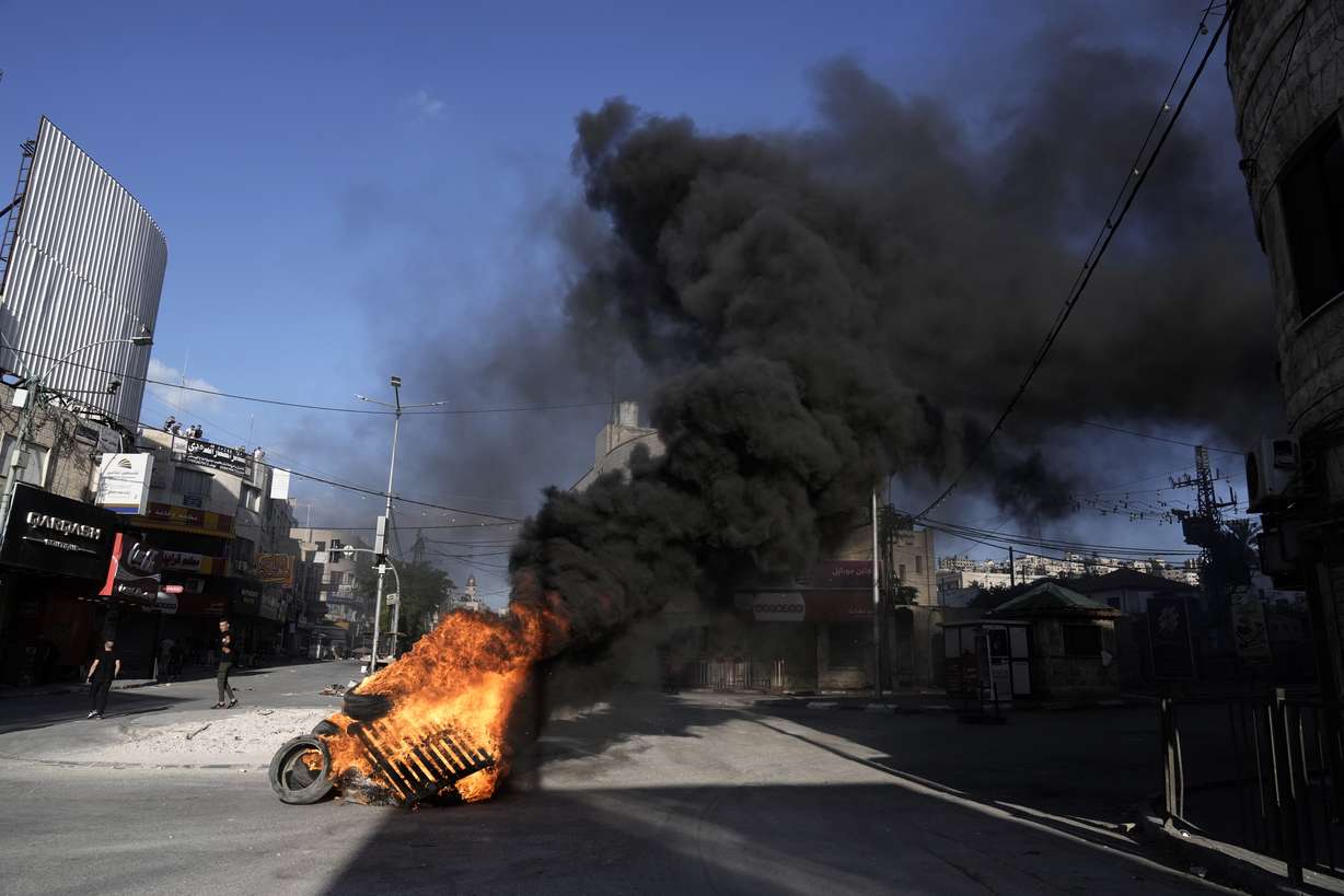 Tires burn as Israeli forces Israeli forces operate in the Balata refugee camp, in the West Bank city of Nablus, Saturday. The Israeli military said that its forces conducted counterterrorism activity in the area overnight.