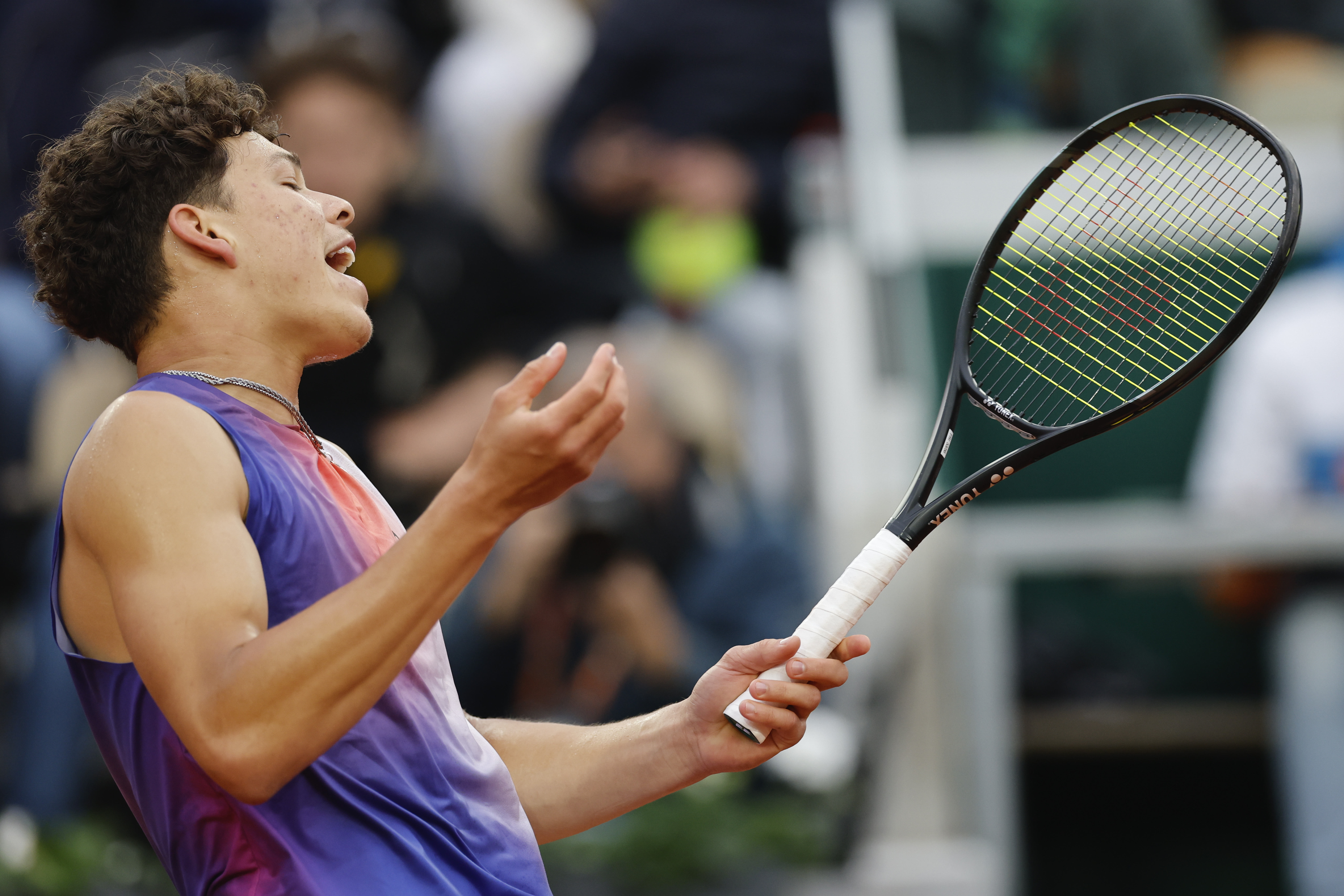 Ben Shelton of the U.S. reacts after missing a shot against Canada's Felix Auger-Aliassime during their third round match of the French Open tennis tournament at the Roland Garros stadium in Paris, Saturday, June 1, 2024. 