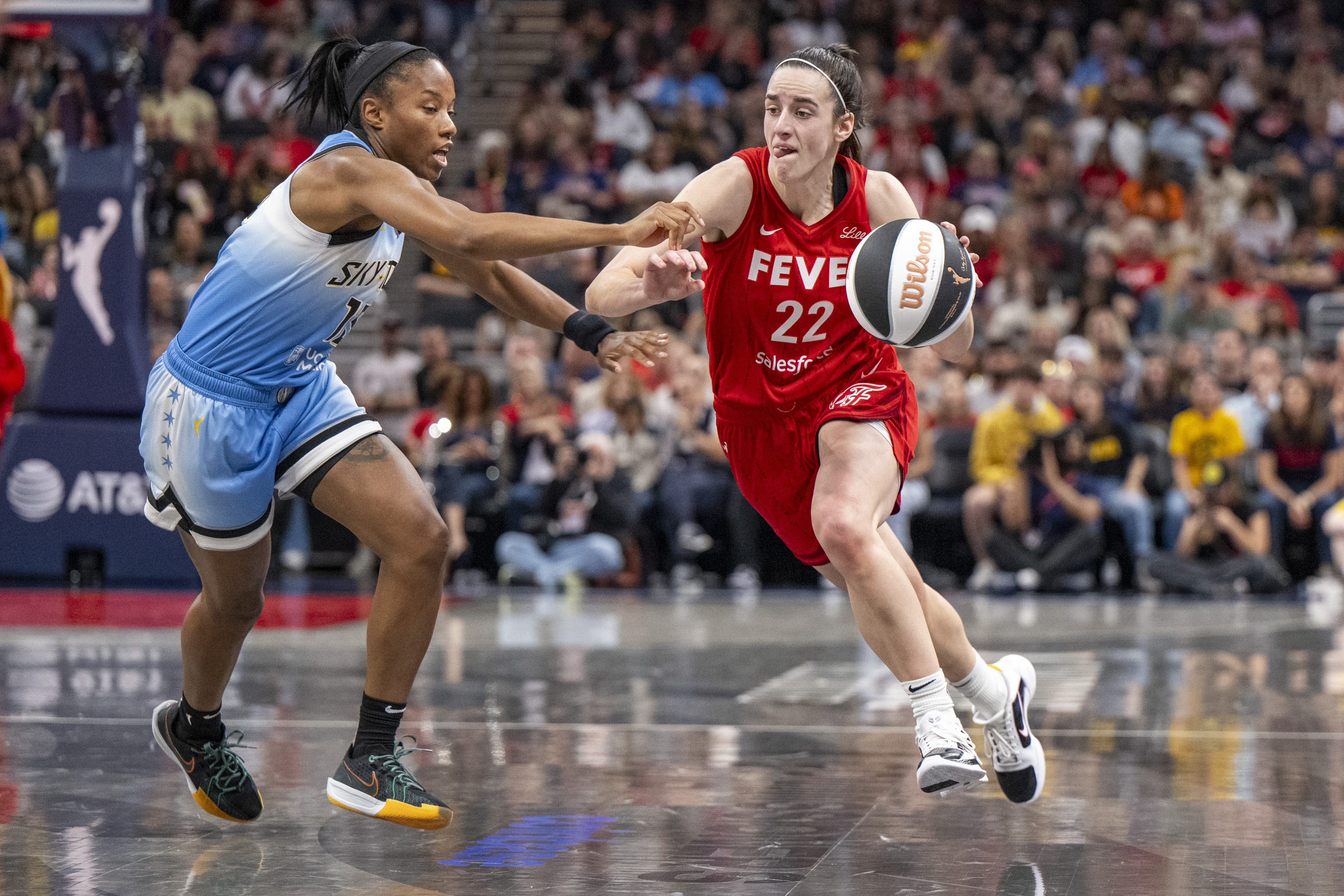 Indiana Fever guard Caitlin Clark (22) makes a move around the defense of Chicago Sky guard Lindsay Allen, left, during a WNBA basketball game Saturday, June 1, 2024, in Indianapolis. 