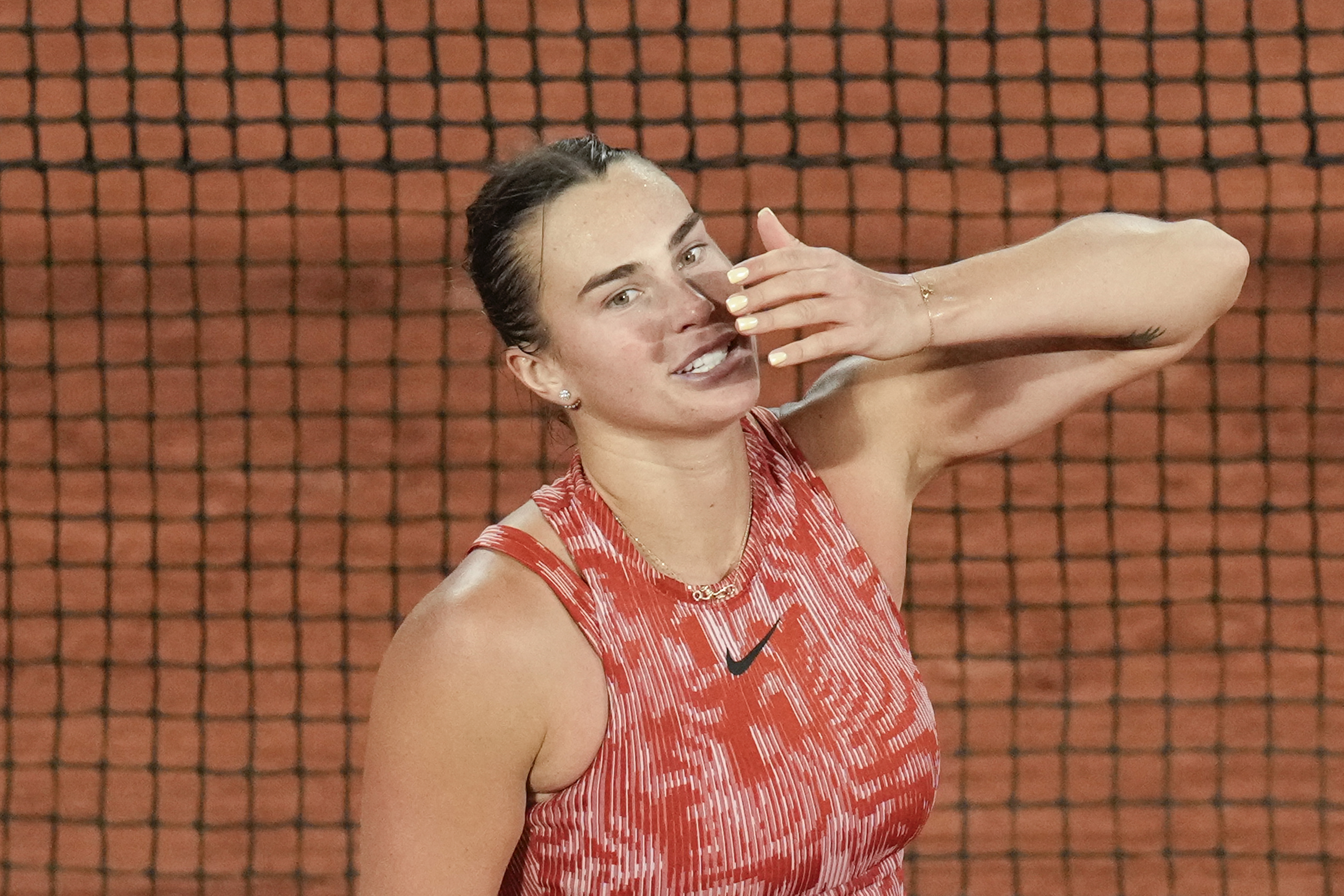 Aryna Sabalenka of Belarus blows a kiss to cheering tennis fans after winning her third round match of the French Open tennis tournament against Spain's Paula Badosa at the Roland Garros stadium in Paris, Saturday, June 1, 2024. 