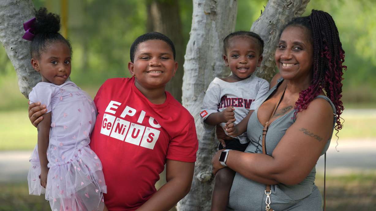 Tamika Davis, right, poses with three of her children, from left, Shanara, 3, Matthew, 11, and Lionel Jr., 2, at MLK Park in San Antonio, Thursday. Davis said friends and family watched her kids for most of her doctor visits during treatment last year for colon cancer. But she couldn't afford additional child care, and she didn't know where to look for assistance.