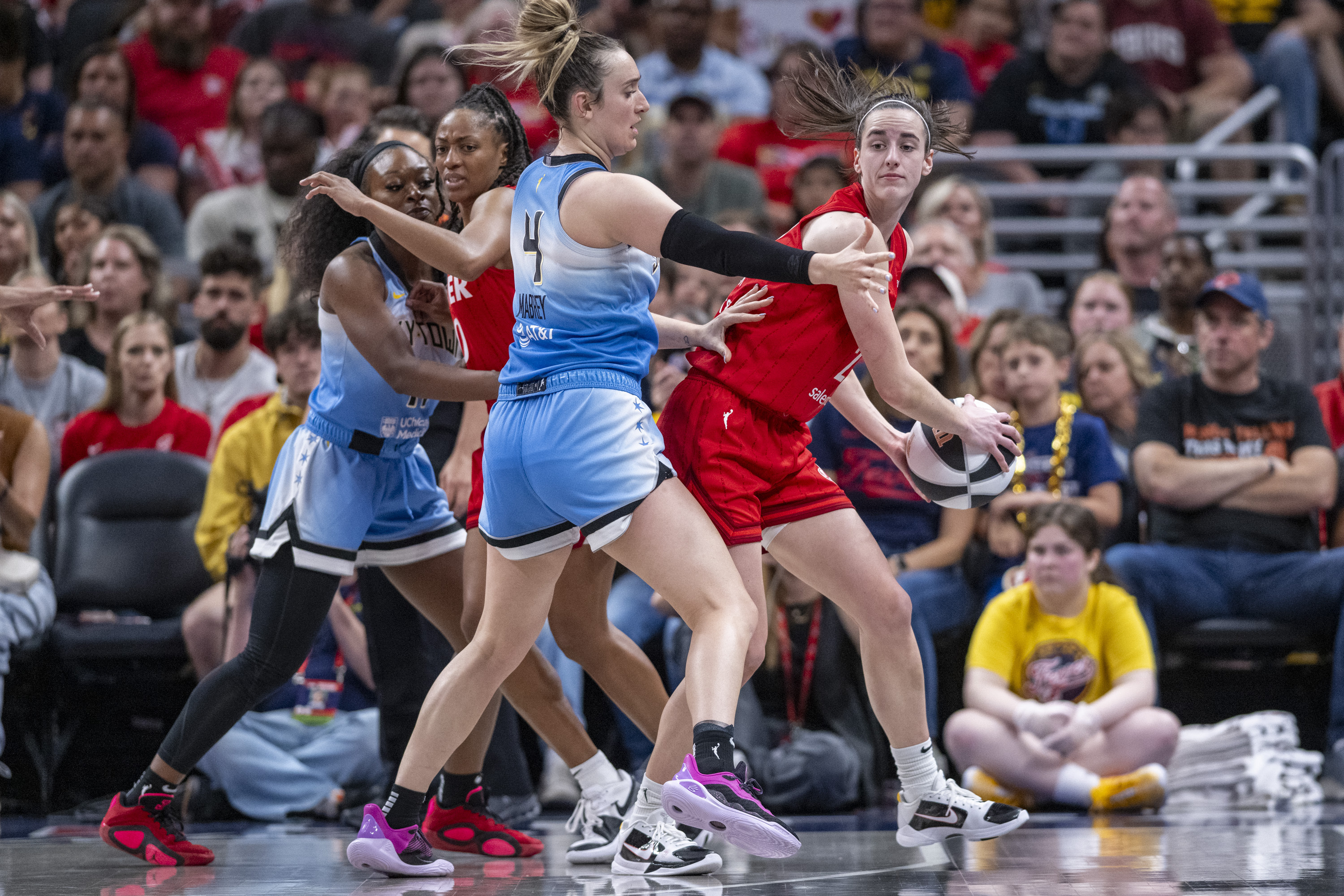 Indiana Fever guard Caitlin Clark, right, looks to pass as Chicago Sky guard Marina Mabrey (4) defends during the second half of a WNBA basketball game Saturday, June 1, 2024, in Indianapolis. 