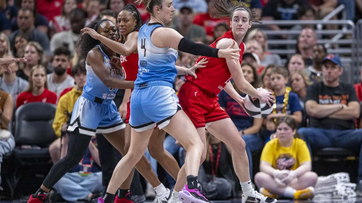 Indiana Fever guard Caitlin Clark, right, looks to pass as Chicago Sky guard Marina Mabrey (4) defends during the second half of a WNBA basketball game Saturday, June 1, 2024, in Indianapolis.
