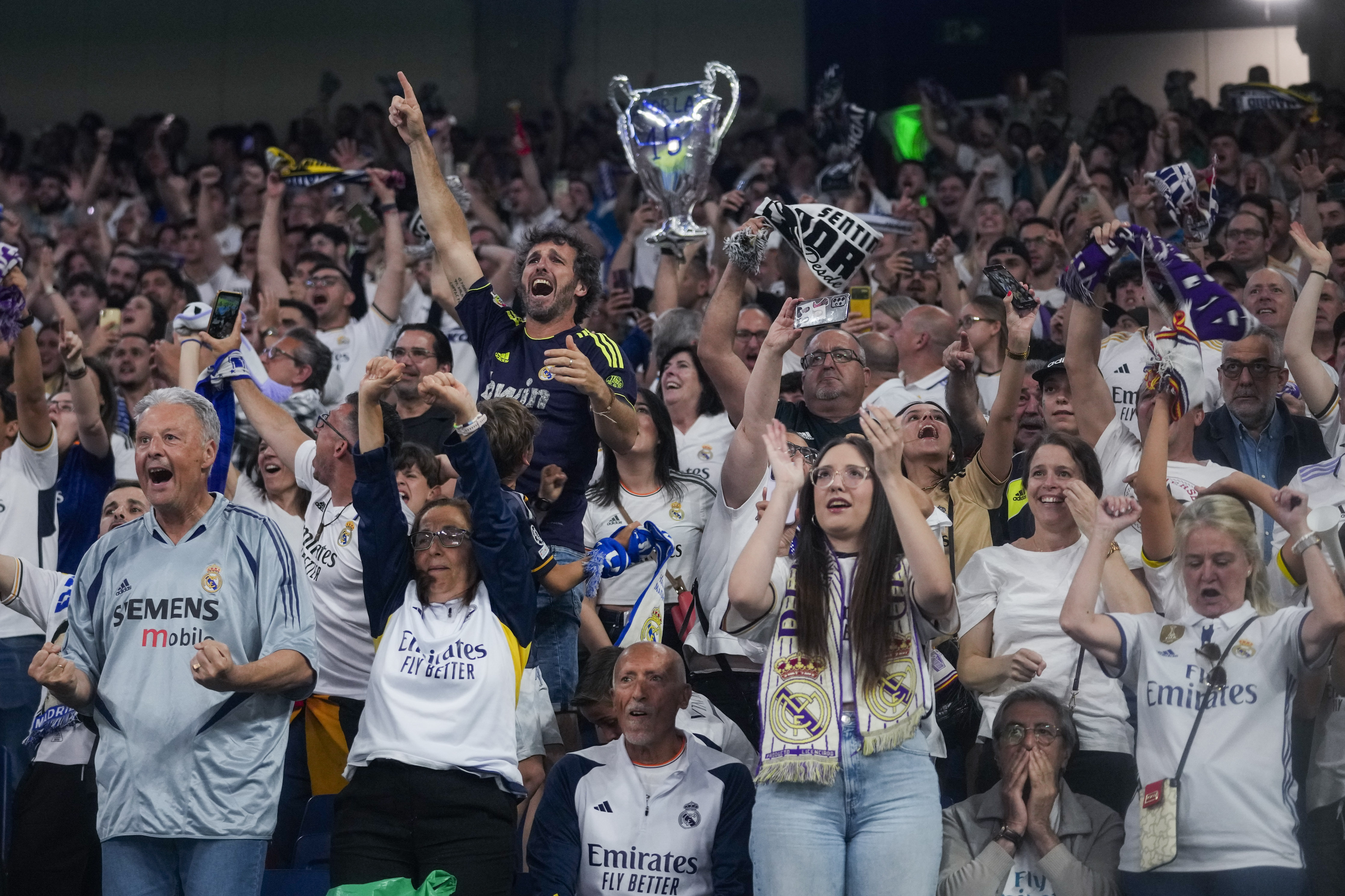 Real Madrid fans celebrate their team goal as they wat the Champions League final soccer match between Real Madrid and Borussia Dortmund at Santiago Bernabeu stadium, in Madrid, Spain, Saturday, June 1, 2024. 