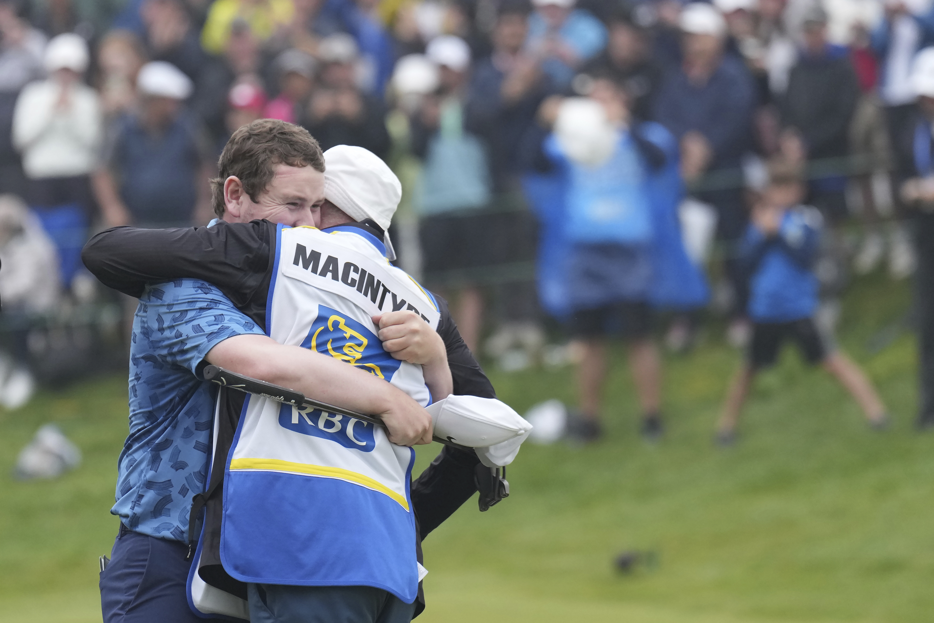 Scotland's Robert MacIntyre celebrates with his father Dougie MacIntyre after winning the Canadian Open golf tournament in Hamilton, Ontario, Sunday, June 2, 2024. 