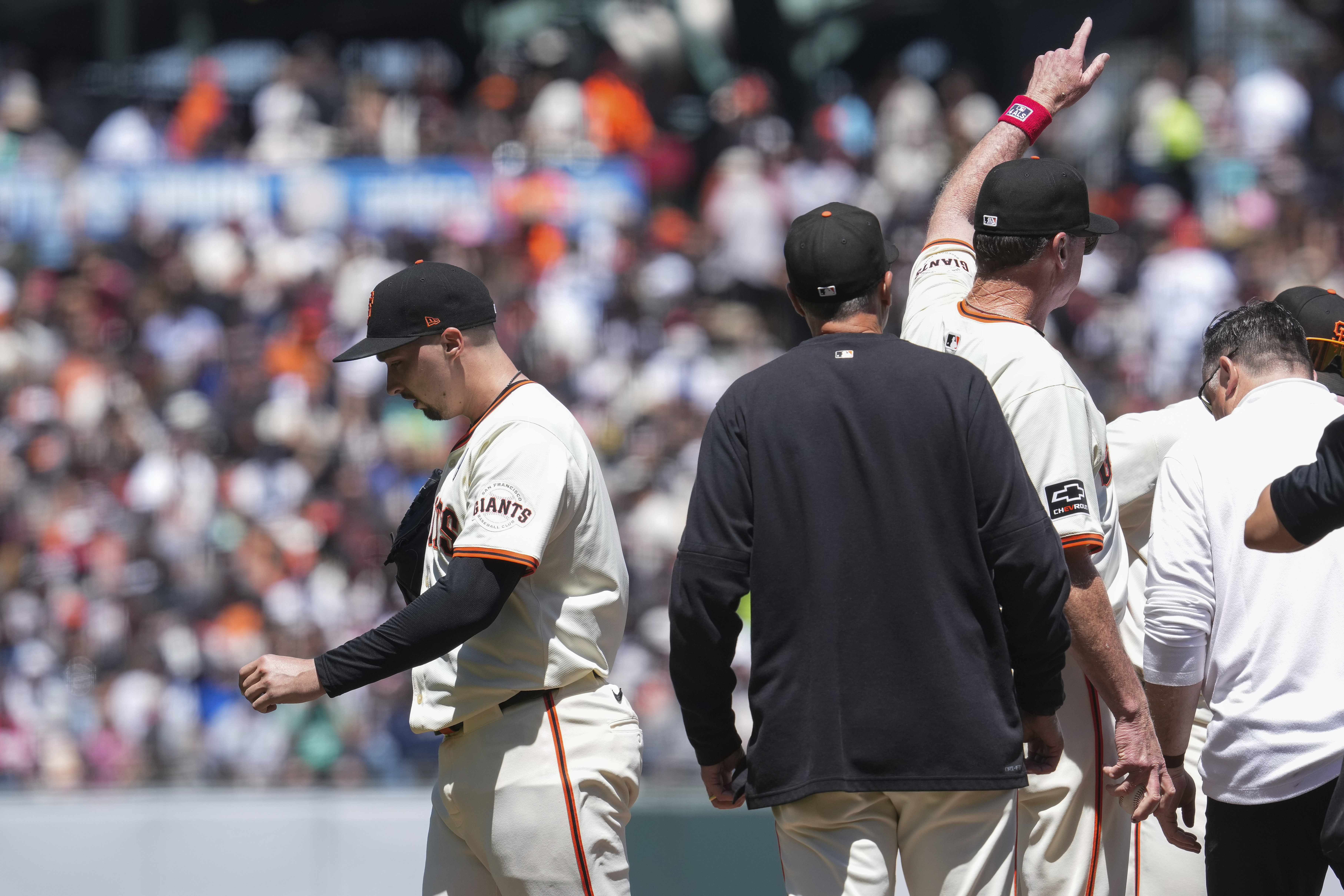 San Francisco Giants manager Bob Melvin, third from left, signals of the bullpen as pitcher Blake Snell, left, exits during the fifth inning of a baseball game against the New York Yankees, Sunday, June 2, 2024, in San Francisco. 