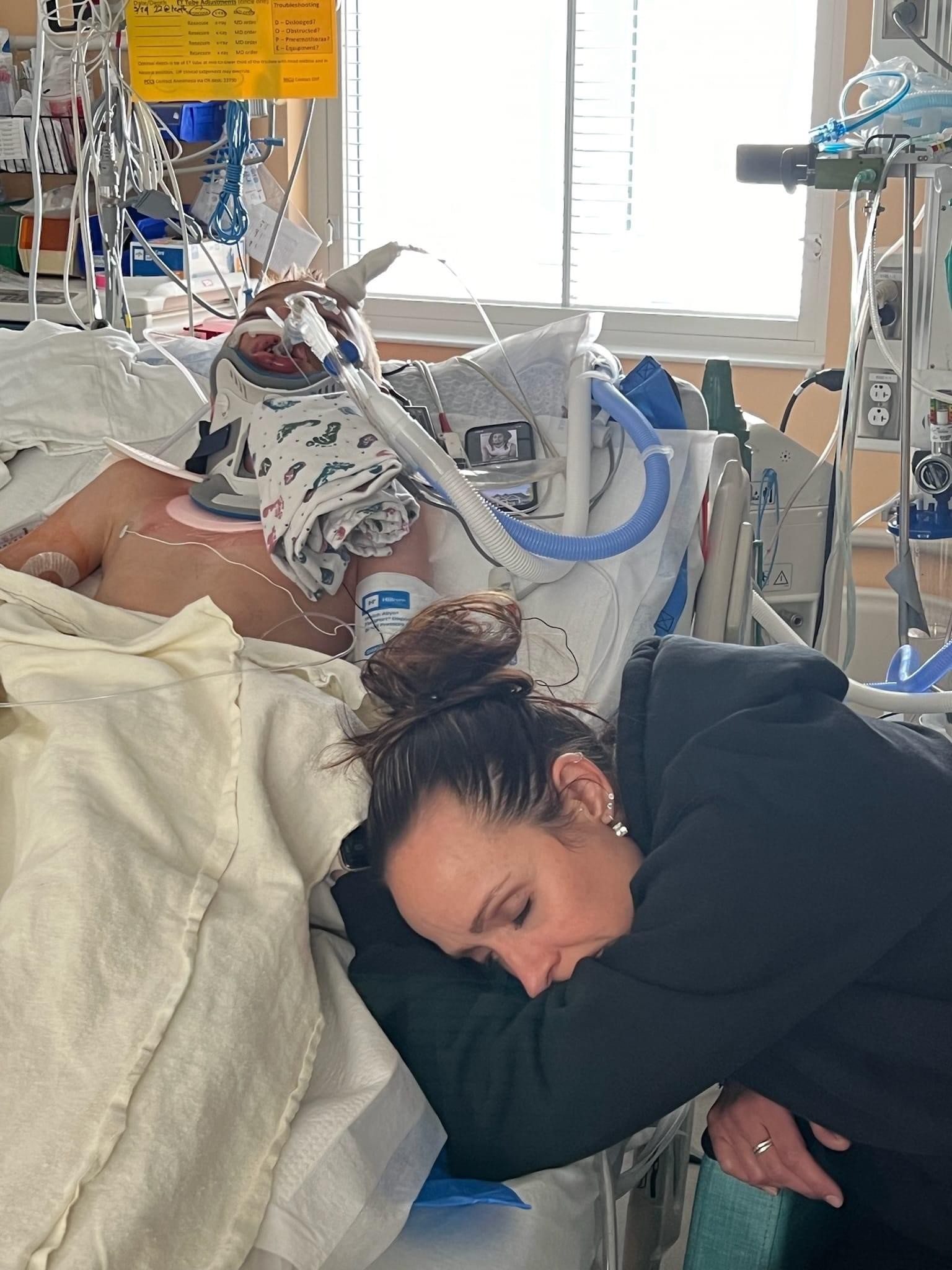 Tiffany Vendela at the bedside of her son Trayden at Primary Children's Hospital in Salt Lake City. The community is hoping for the 9-year-old boy's recovery after he was hit by a car while riding his bike in Huntsville on Wednesday.