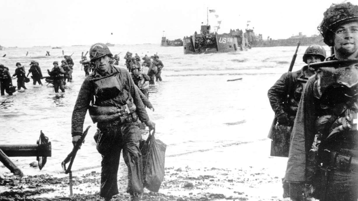 Carrying full equipment, American assault troops move onto a beachhead code-named Omaha Beach, on the northern coast of France on June 6, 1944, during the Allied invasion of the Normandy coast.