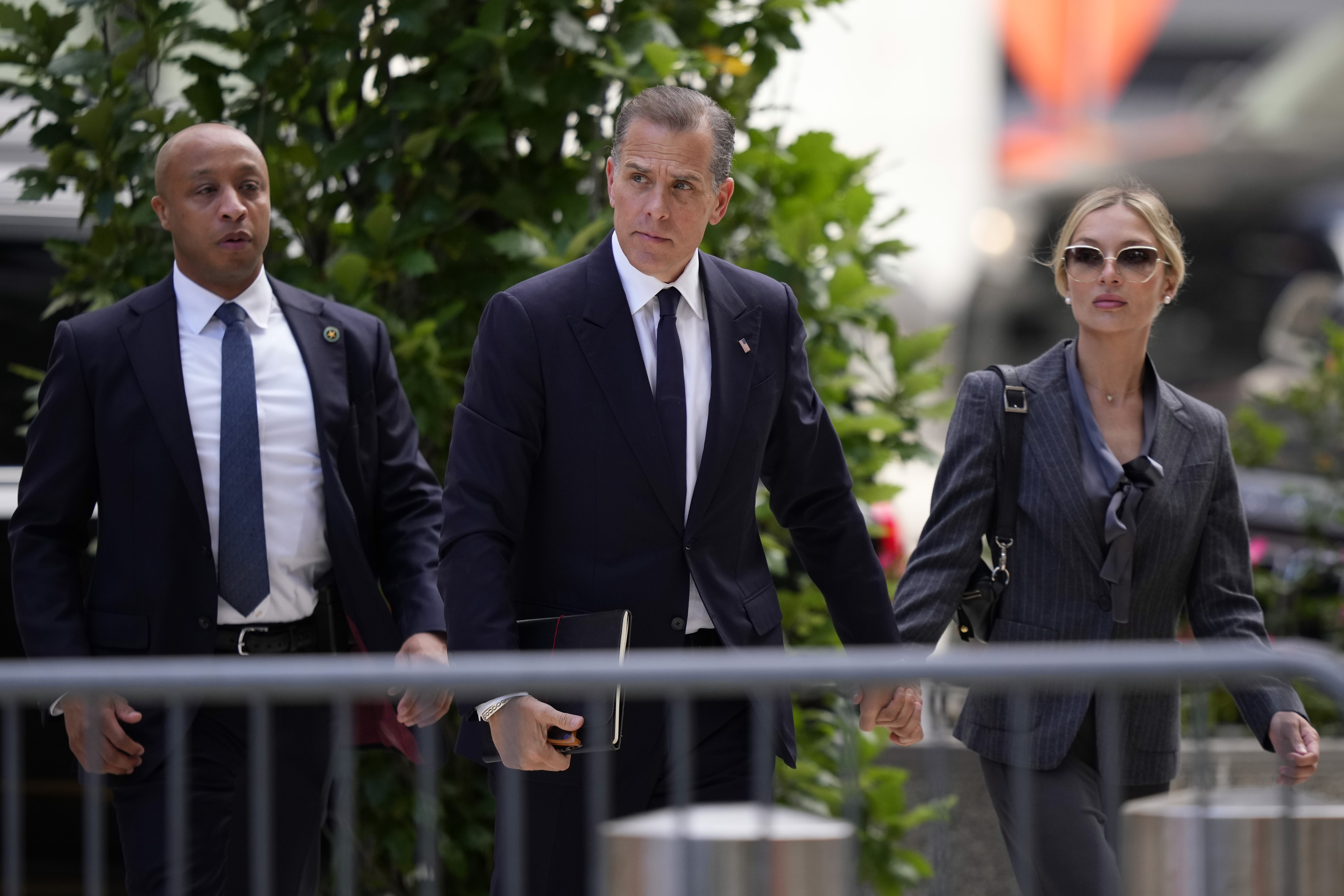 Hunter Biden, center, and his wife, Melissa Cohen Biden, right, arrive at federal court, Monday, in Wilmington, Del.