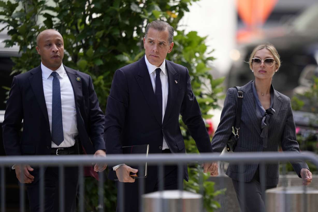 Hunter Biden, center, and his wife, Melissa Cohen Biden, right, arrive at federal court, Monday, in Wilmington, Del.