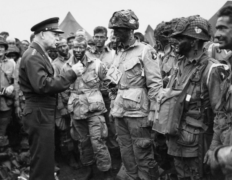 Gen. Dwight D. Eisenhower, Allied commander in chief, speaks with American paratroopers at an undisclosed location in England, June 6, 1944, prior to plans to participate in the first assault on the coast of France during D-Day.