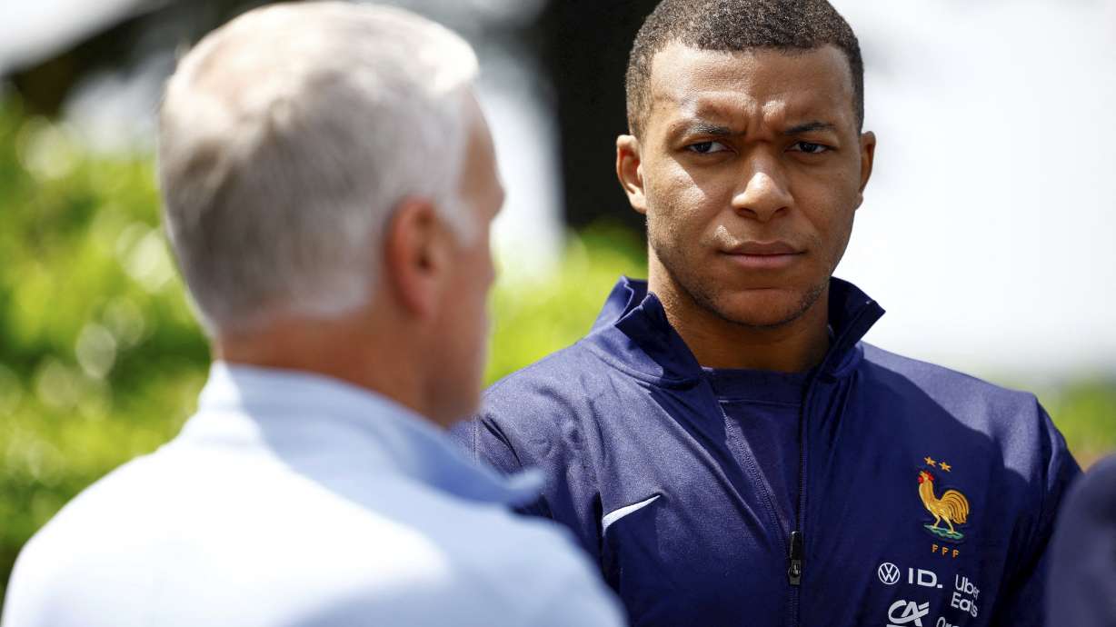 French soccer player Kylian Mbappe, right, listening to head coach Didier Deschamps at the national soccer team training center in Clairefontaine, west of Paris, Monday, June 3, 2024 ahead of the UEFA Euro 2024.