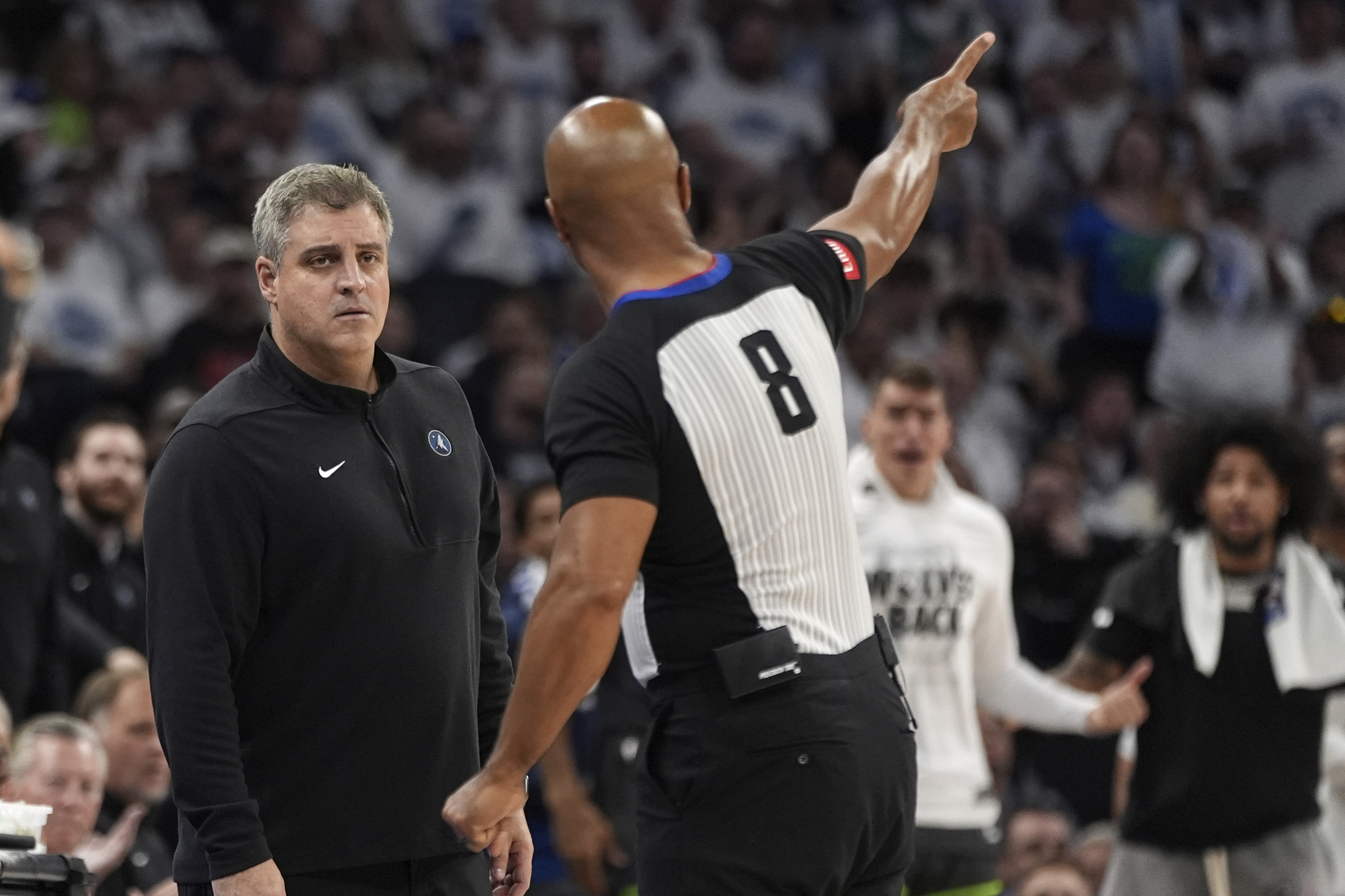 Minnesota Timberwolves assistant coach Micah Nori, left, listens to referee Marc Davis (8) explain a call during the second half of Game 5 of the Western Conference finals in the NBA basketball playoffs against the Dallas Mavericks, Thursday, May 30, 2024, in Minneapolis. 