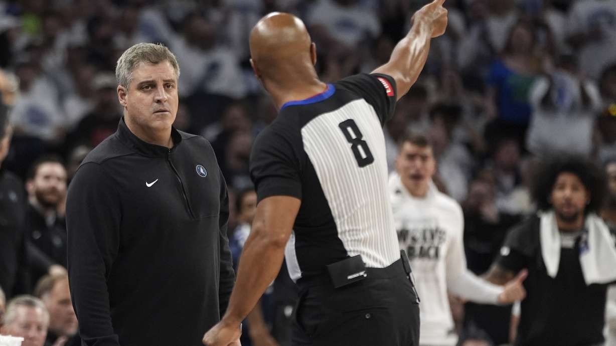 Minnesota Timberwolves assistant coach Micah Nori, left, listens to referee Marc Davis (8) explain a call during the second half of Game 5 of the Western Conference finals in the NBA basketball playoffs against the Dallas Mavericks, Thursday, May 30, 2024, in Minneapolis.