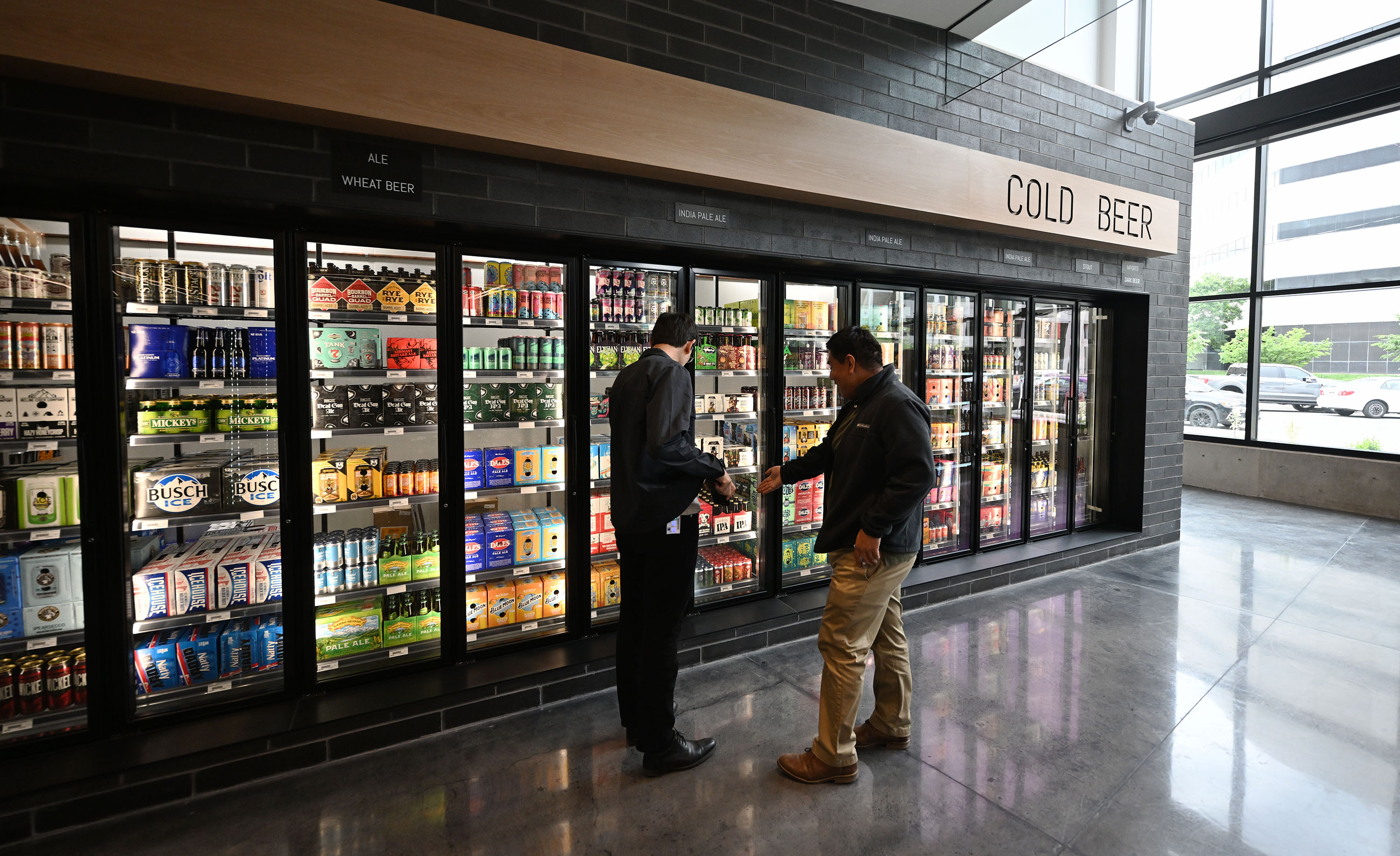 A pair of customers examine the cooler selection at the new state liquor store in Salt Lake City that opened on Monday.