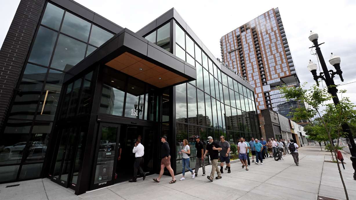 Customers enter the new state liquor store in Salt Lake City on Monday. The location is Utah's first two-story liquor store and is expected to generate $13 million in sales during the upcoming fiscal year.