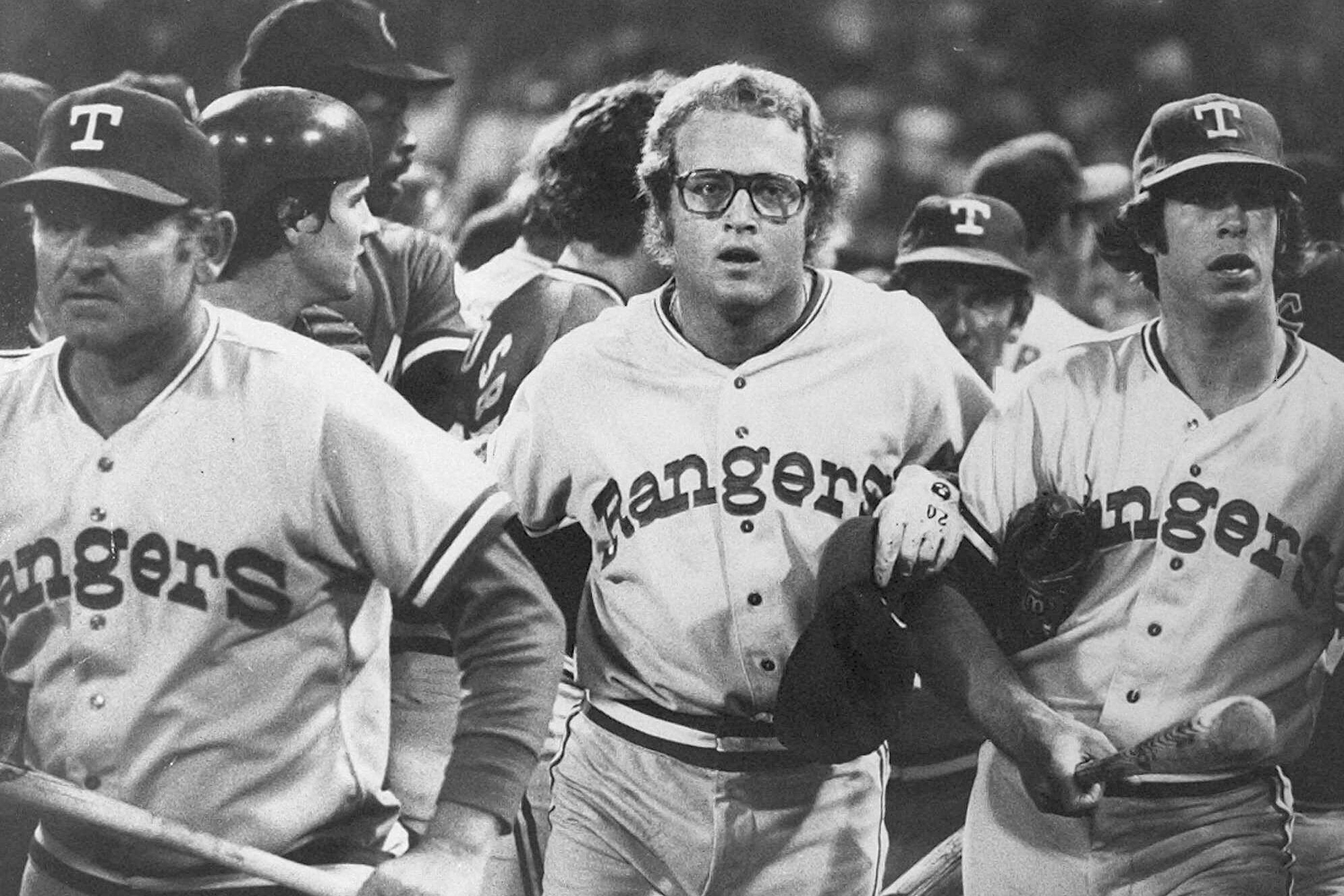 FILE - In this image provided by Special Collections, Cleveland State University, Texas Rangers' Jeff Burroughs, center, runs off the field with his teammates during the Beer Night melee at Cleveland Stadium, June 4, 1974, in Cleveland. The Cleveland Indians forfeited the baseball game to the Rangers after fans, fueled by 10-cent beers, stormed the field in the ninth inning. 