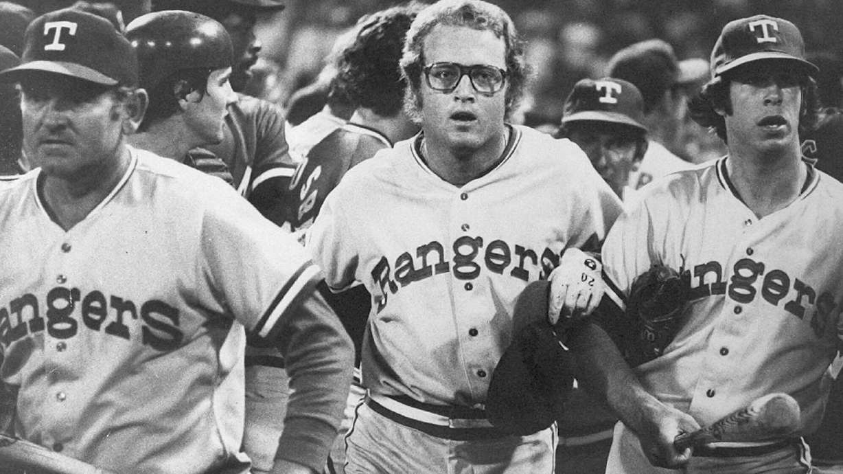 FILE - In this image provided by Special Collections, Cleveland State University, Texas Rangers' Jeff Burroughs, center, runs off the field with his teammates during the Beer Night melee at Cleveland Stadium, June 4, 1974, in Cleveland. The Cleveland Indians forfeited the baseball game to the Rangers after fans, fueled by 10-cent beers, stormed the field in the ninth inning.