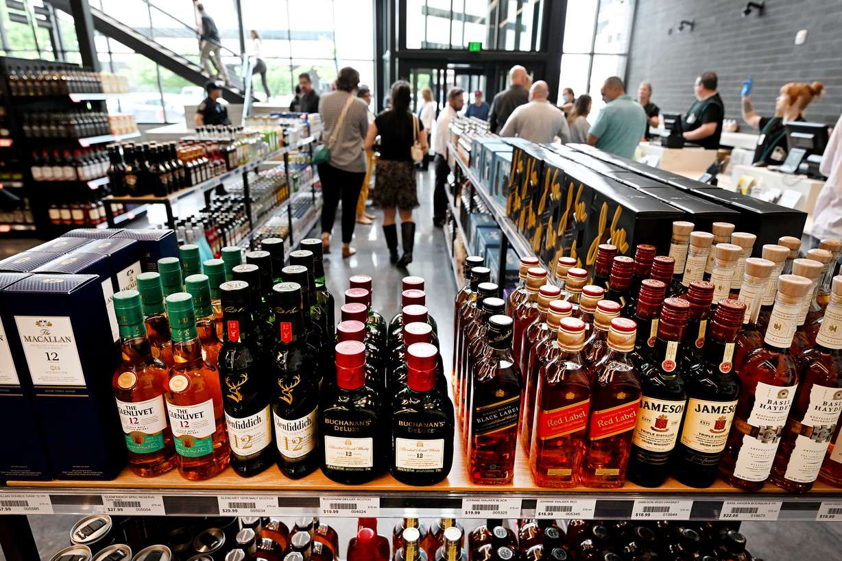 Shoppers line up at the register after shopping at the new state liquor store in Salt Lake City on Monday.