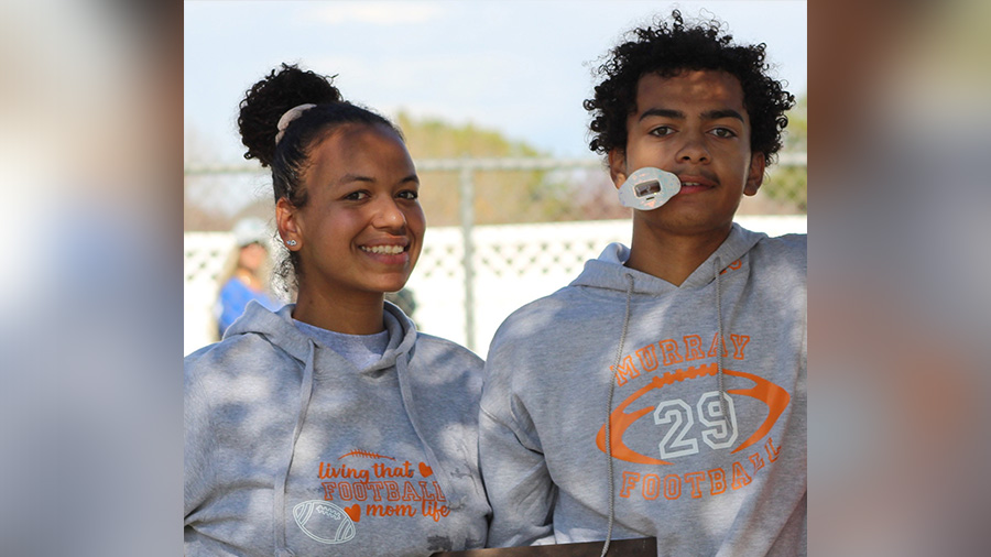 Aspen McCarty is pictured with a family member at a high school football event. McCarty was leaving the Murray North Trax Station near 4500 S. and Main Street when he and two other friends were shot.