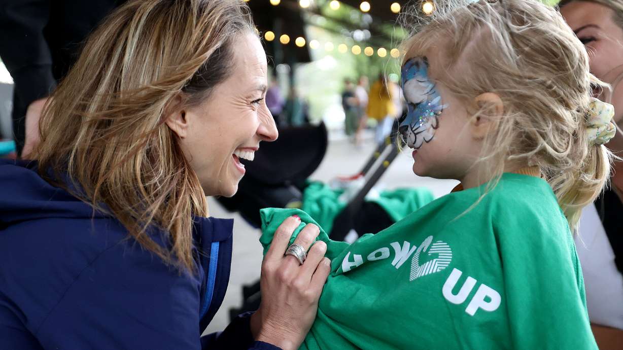 First lady Abby Cox talks to Scottie Schefler, 2, at the Show Up for Summer Service Fair, hosted by Cox, at Electric Park in Lehi on Monday.